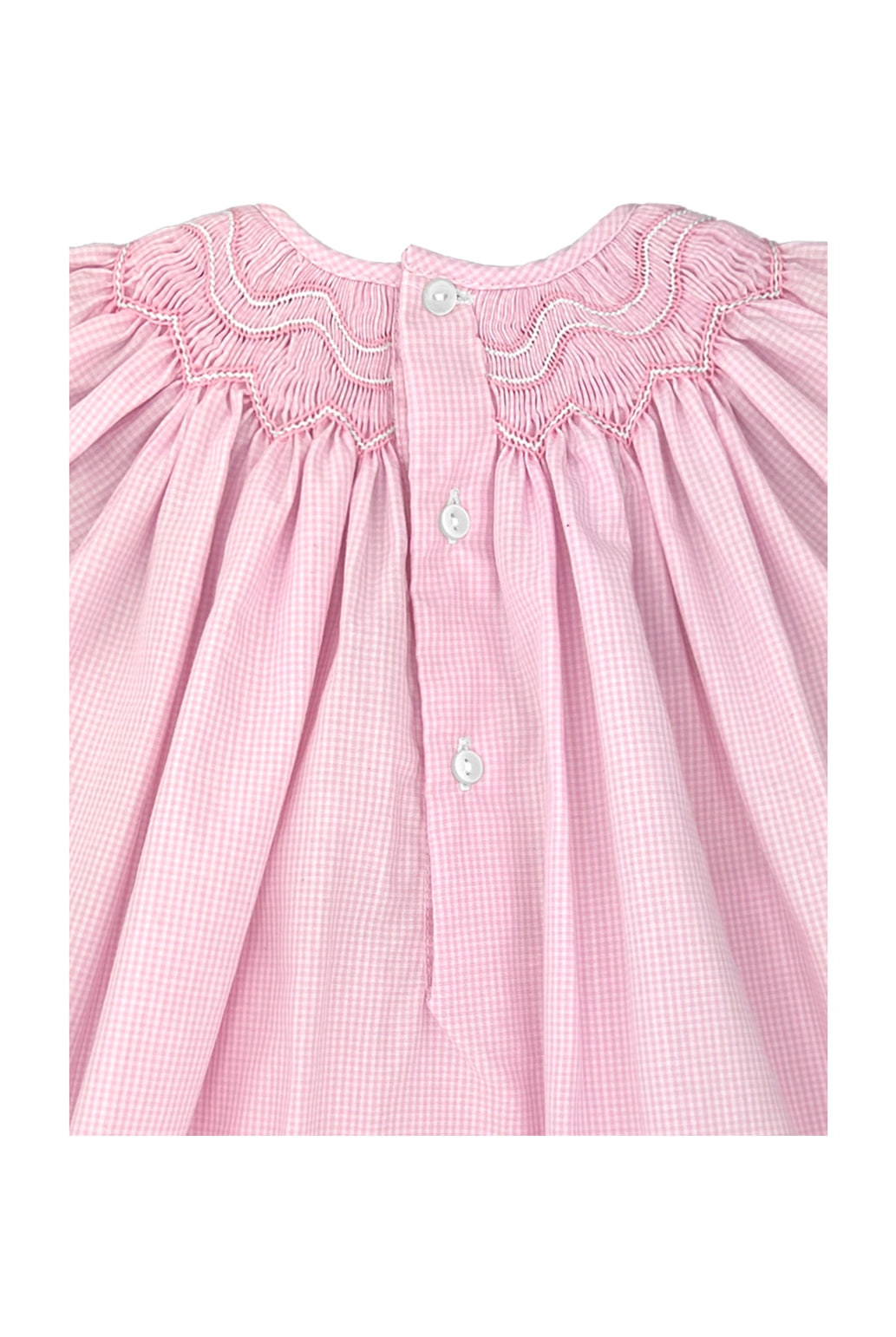 Pink checkered dress with smocked neckline on a white background