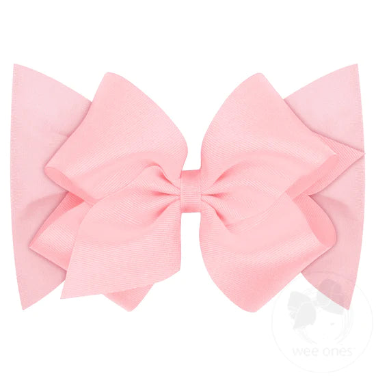 A light pink grosgrain hair bow on a soft cotton jersey band.