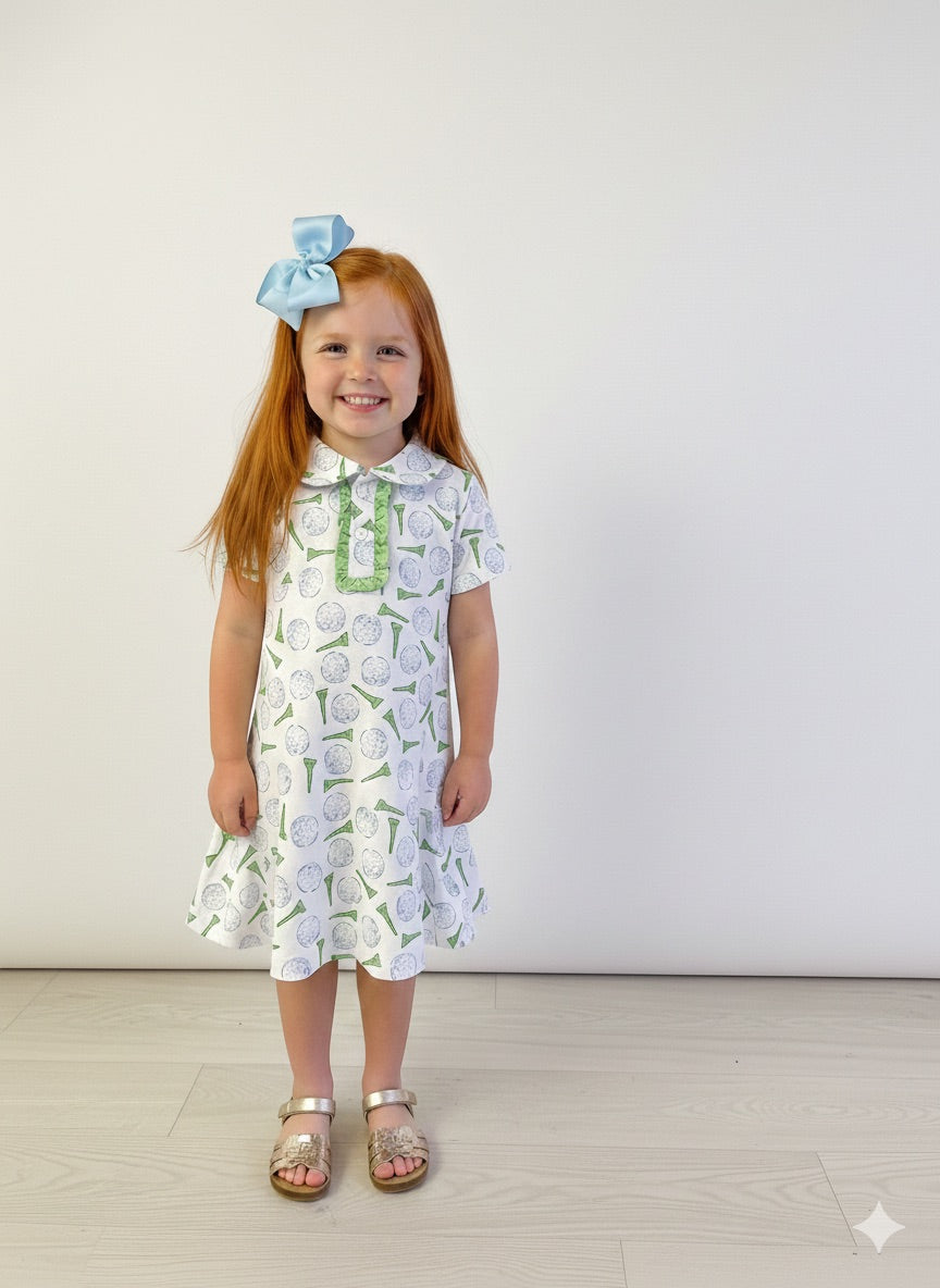 Red head little girl wearing a gold themed collard dress.