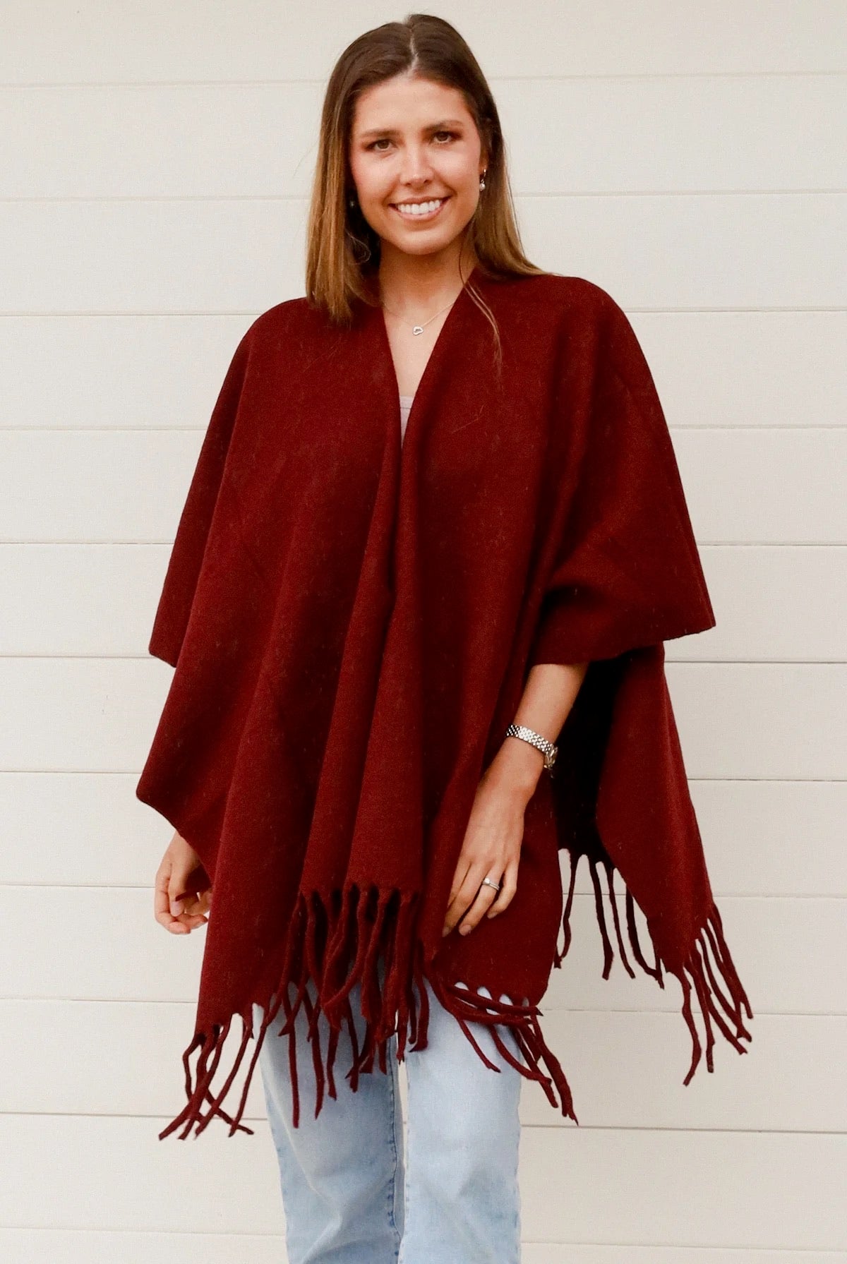Lady wearing a Cabernet colored shaw with fringes.