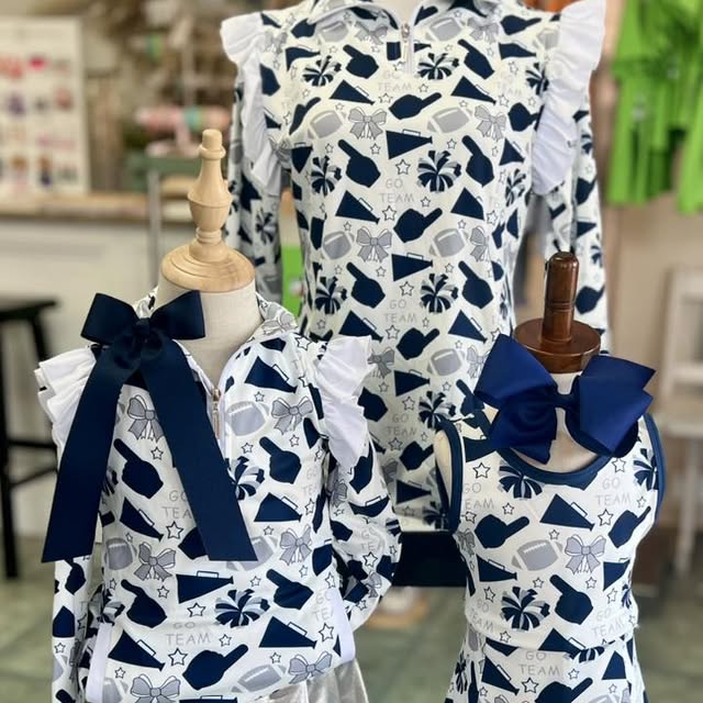 Children's outfit with navy and white pattern on mannequins in a store setting.