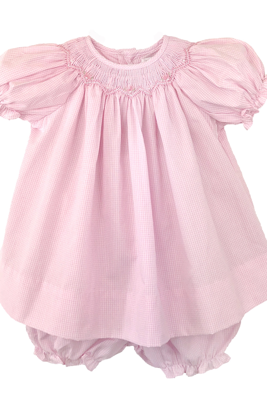 Pink baby dress with ruffled sleeves on a white background
