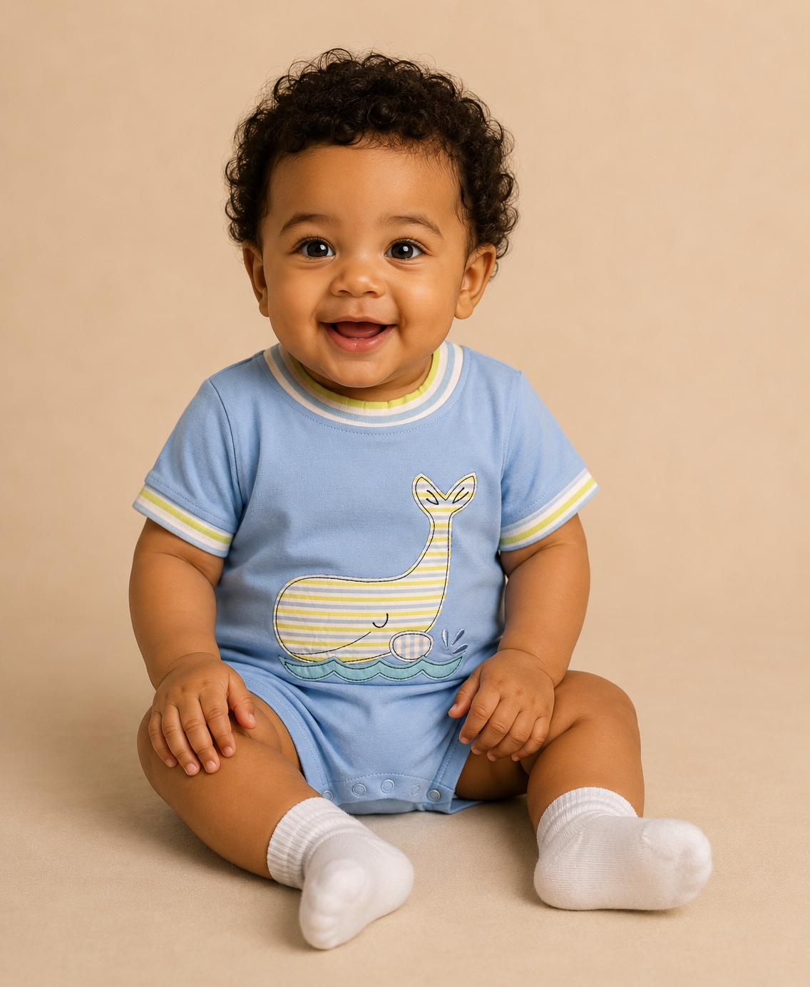 Baby wearing a blue bubble with a whale design on a beige background