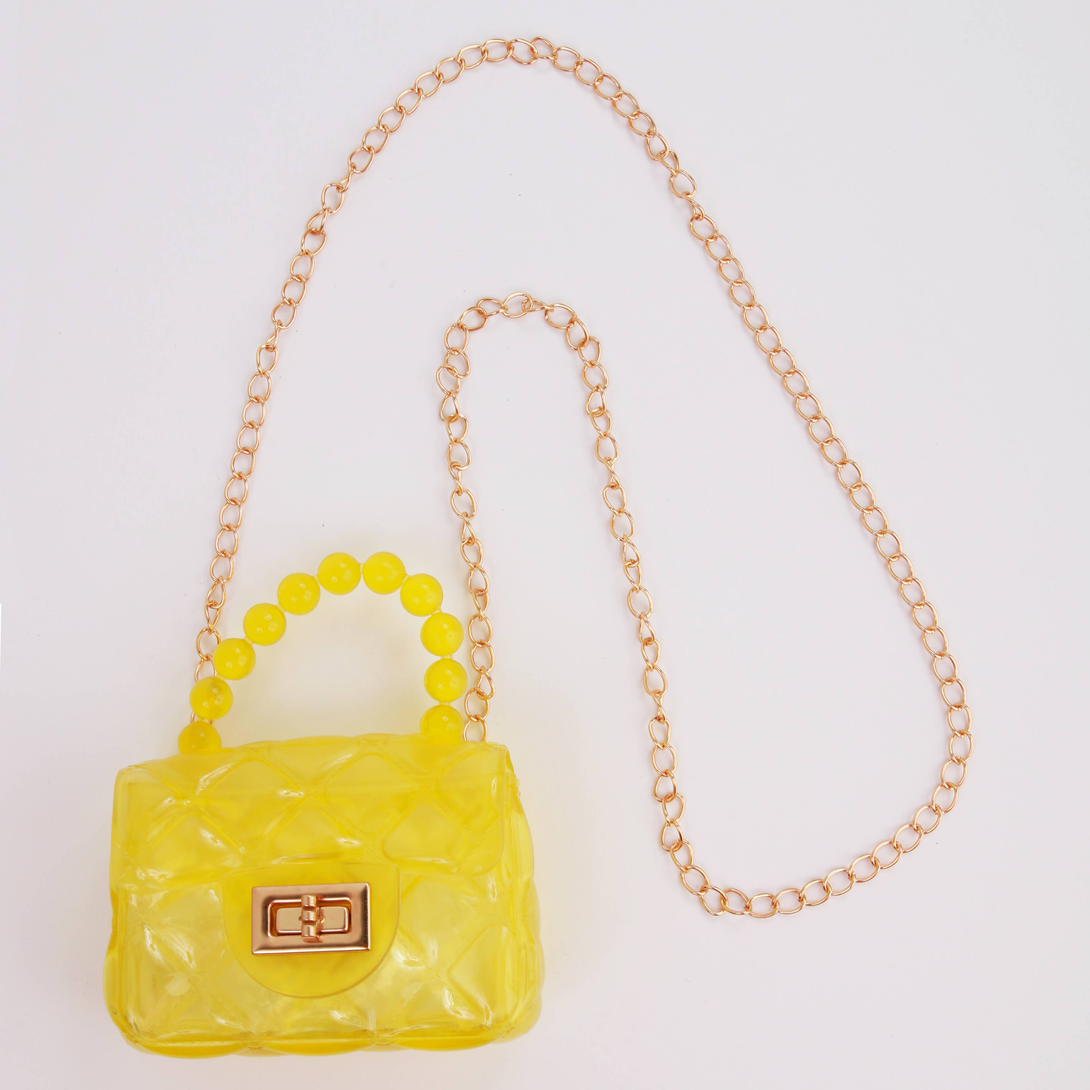 Yellow handbag with a chain strap on a white background