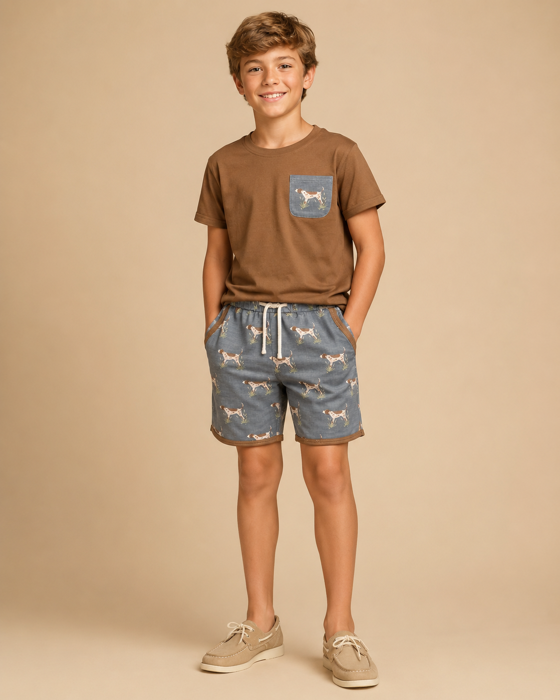 Young boy wearing a brown shirt with a dog print pocket and matching shorts.