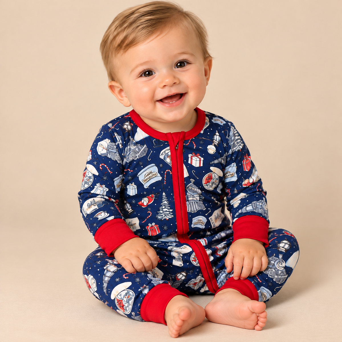 Baby boy wearing zip up polar express lounge wear.
