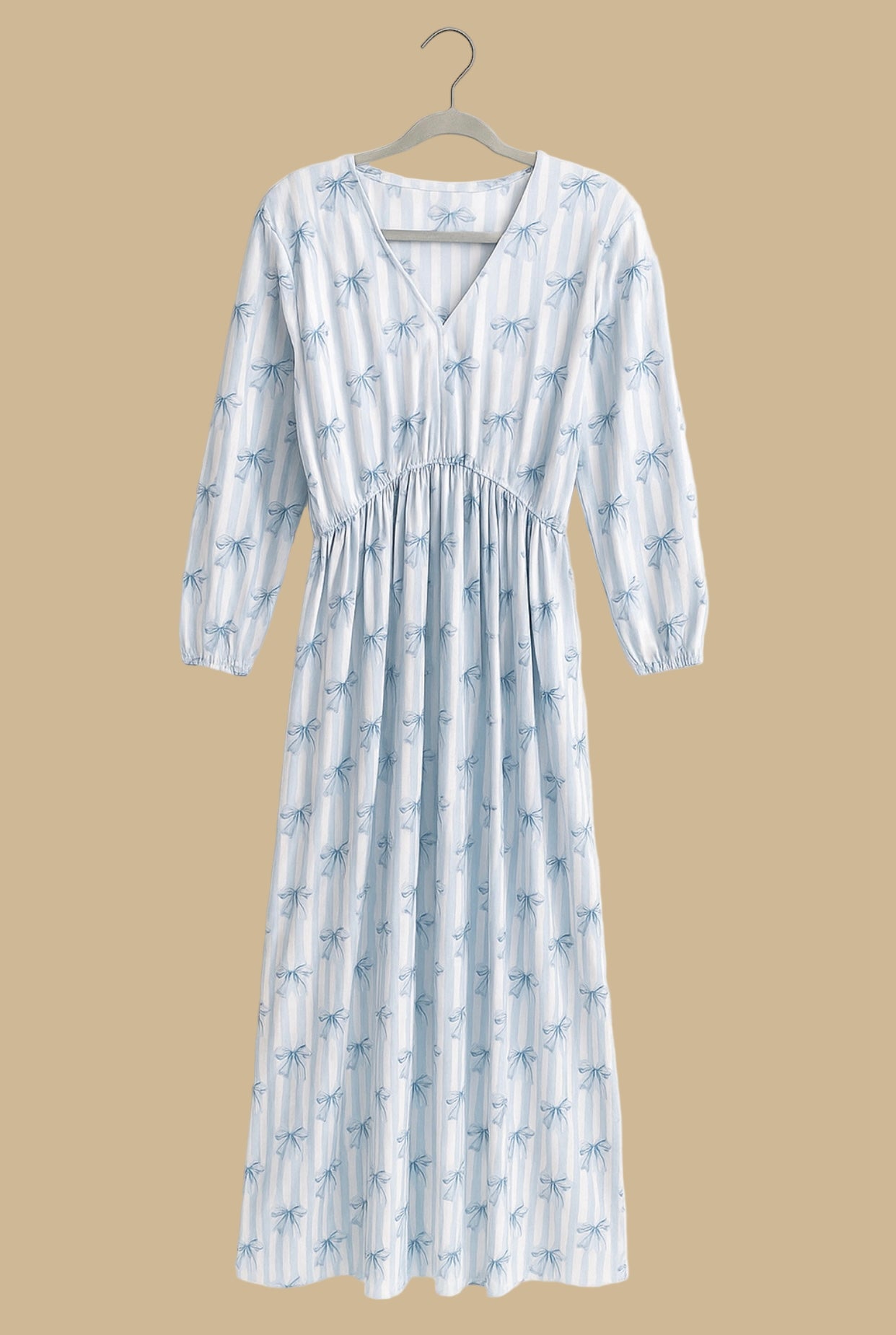 Woman wearing blue and white striped bow print midi dress with long sleeves.