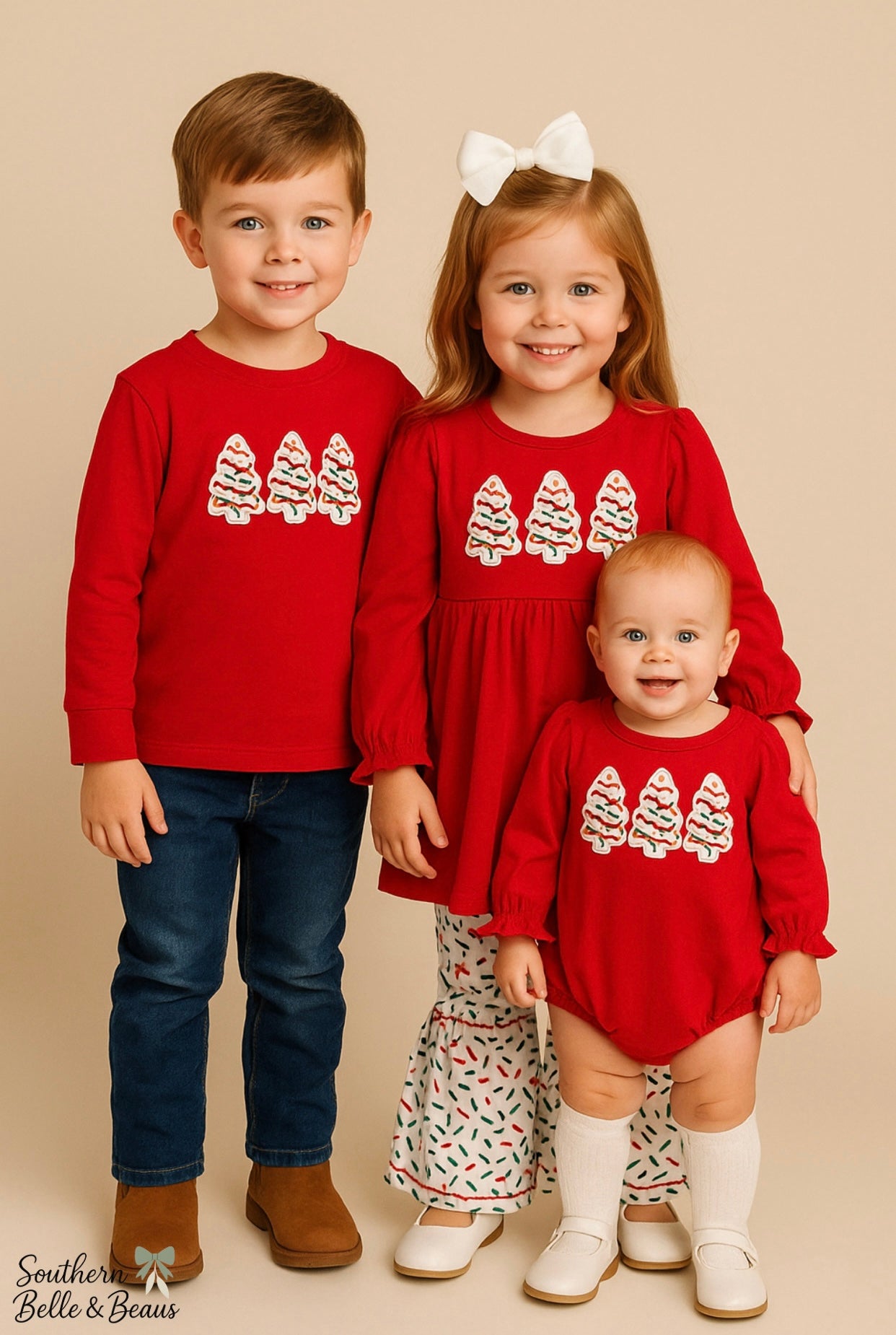 Three children wearing matching Christmas outfits.