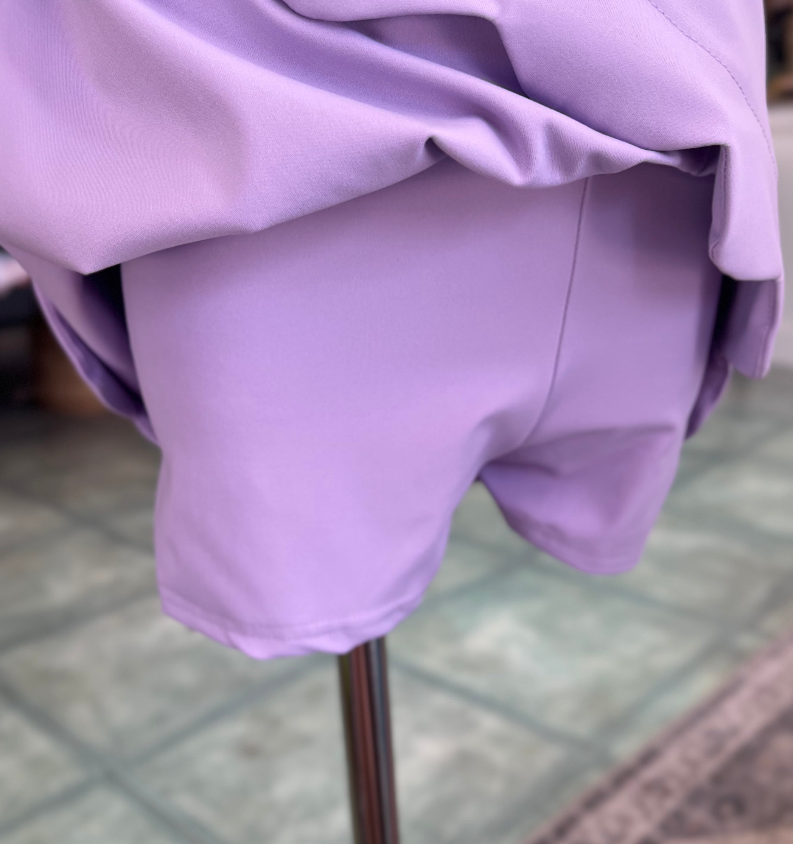 Close-up of a lilac garment on a mannequin with a blurred background