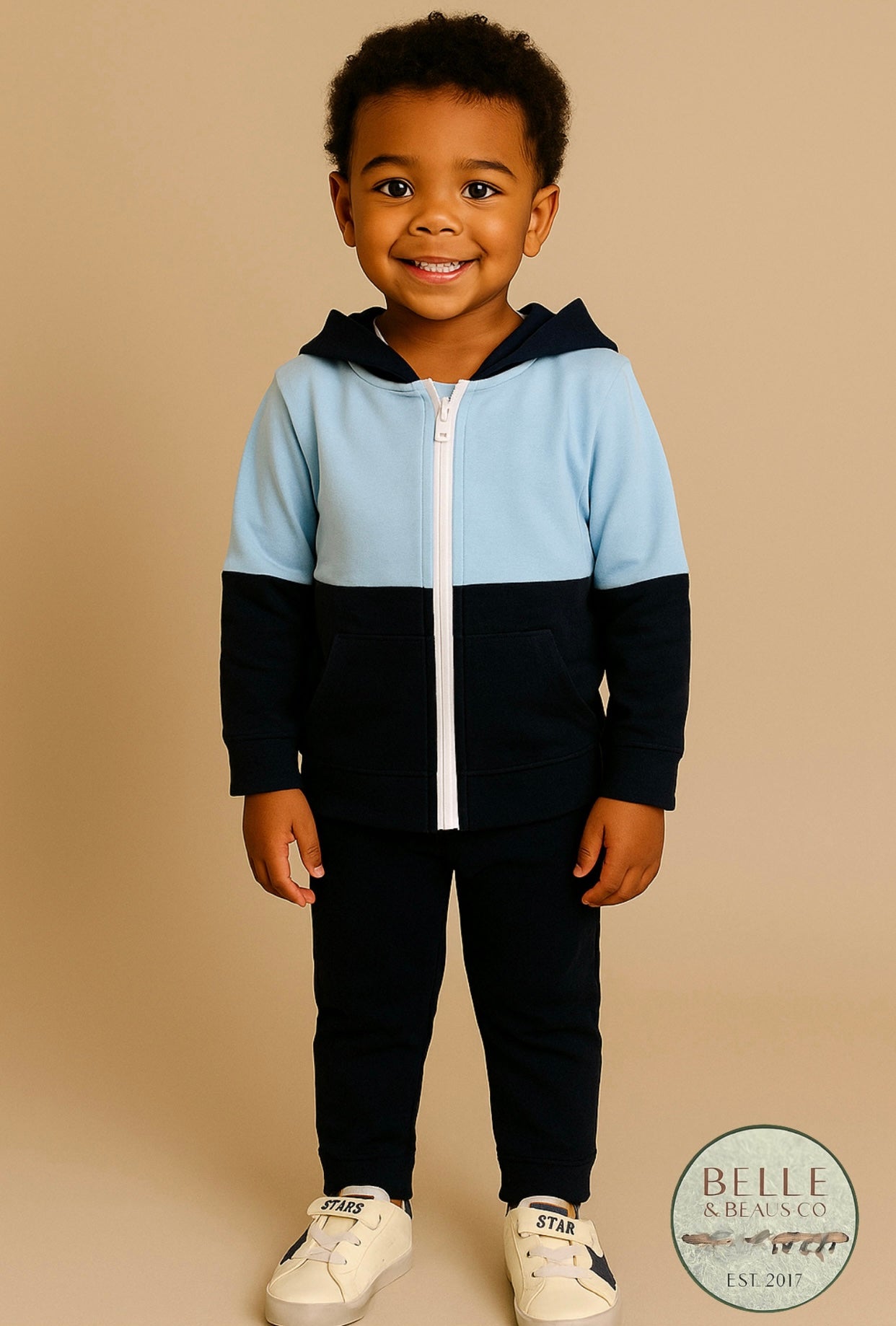 Blue and navy colorblock boys hoodie named “Zayne’s Zip-Up” displayed with white sneakers featuring navy stars from Southern Belle & Beaus.
