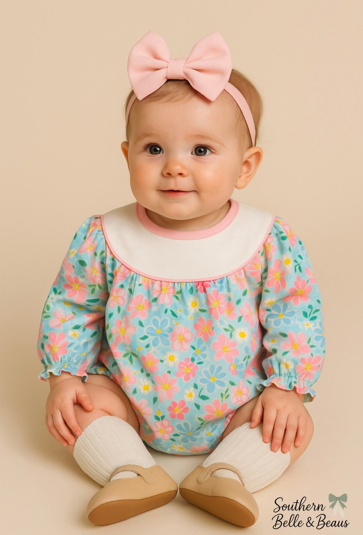 The Garden Kisses Bubble features winter-pastel florals, a white yoke, and sweet elastic details.