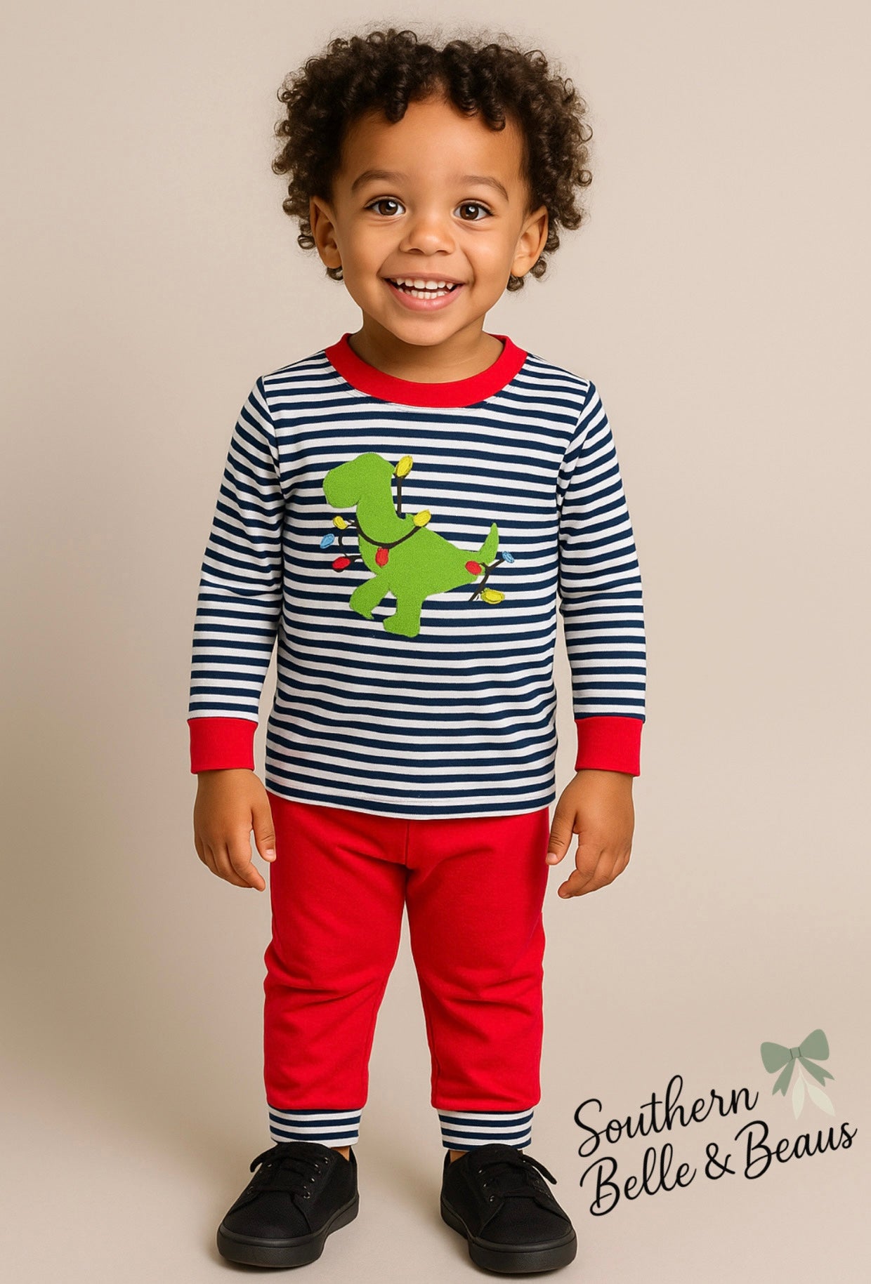 Stripped jogger with a dinosaur tangled in Christmas lights appliqué.