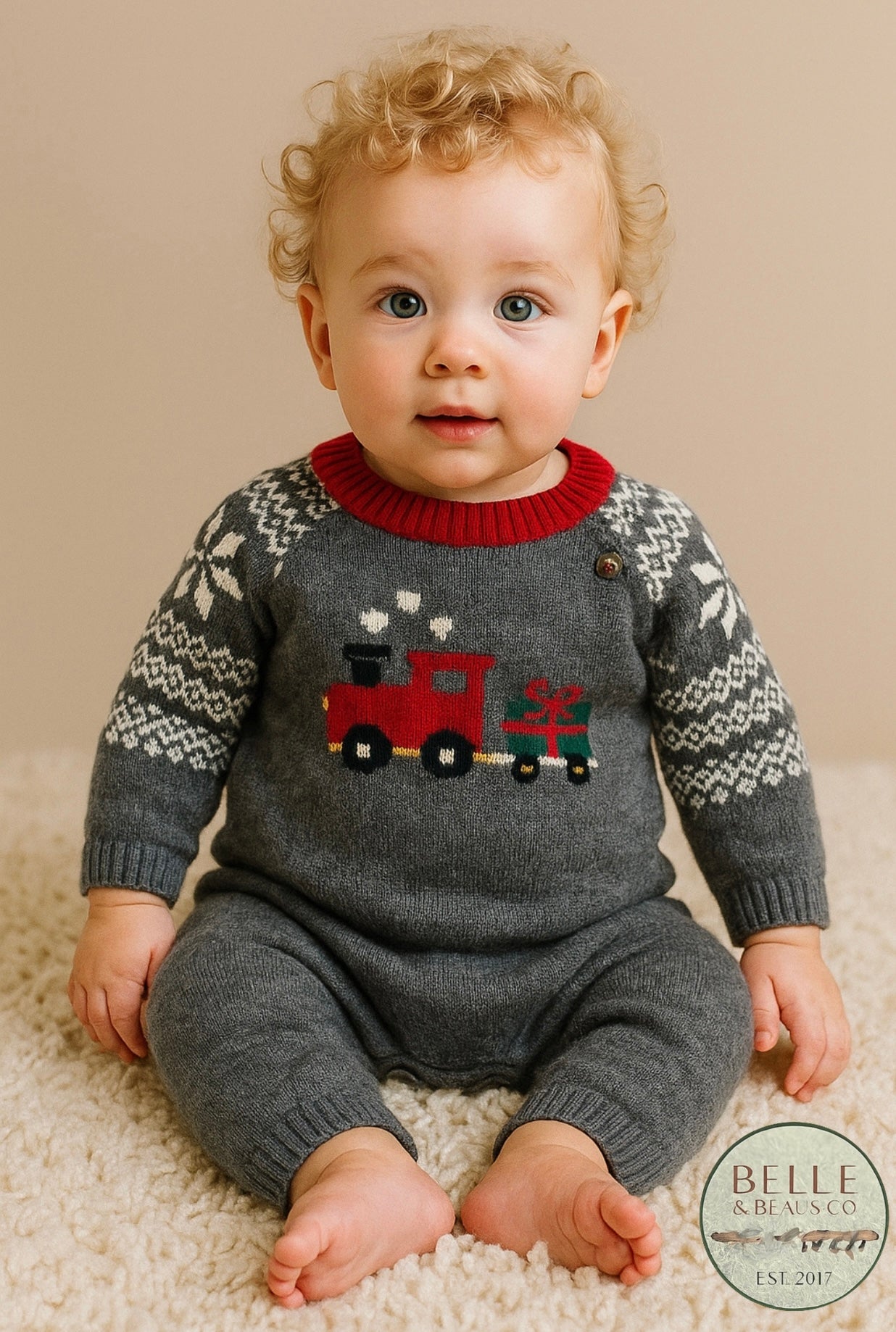Sweater romper for baby boy, grey with train carrying a present, snowflake sleeves.