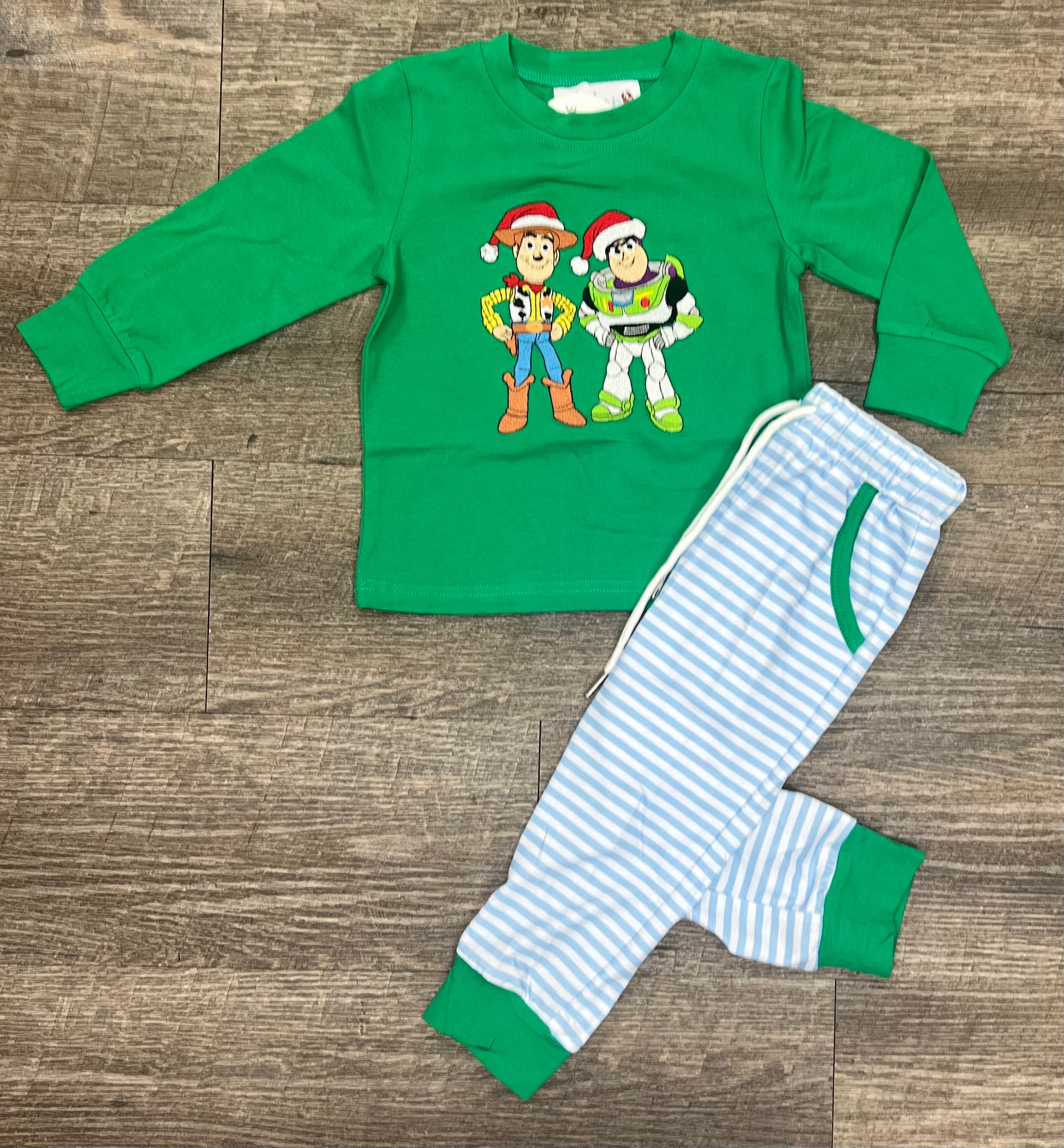 Boys Christmas set with green top featuring cowboy and space ranger characters in Santa hats from the To the North Pole & Beyond Collection by Southern Belle & Beaus.