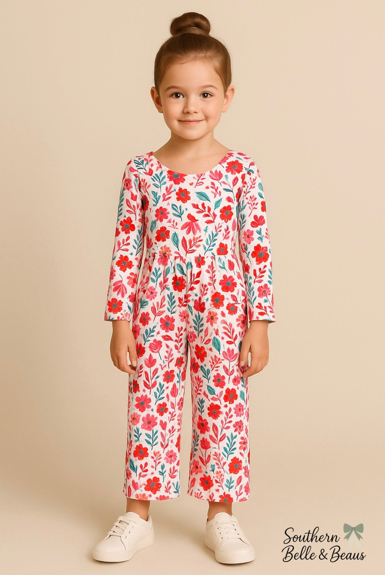 Girls’ long-sleeve jumpsuit with pink, red, and teal floral.