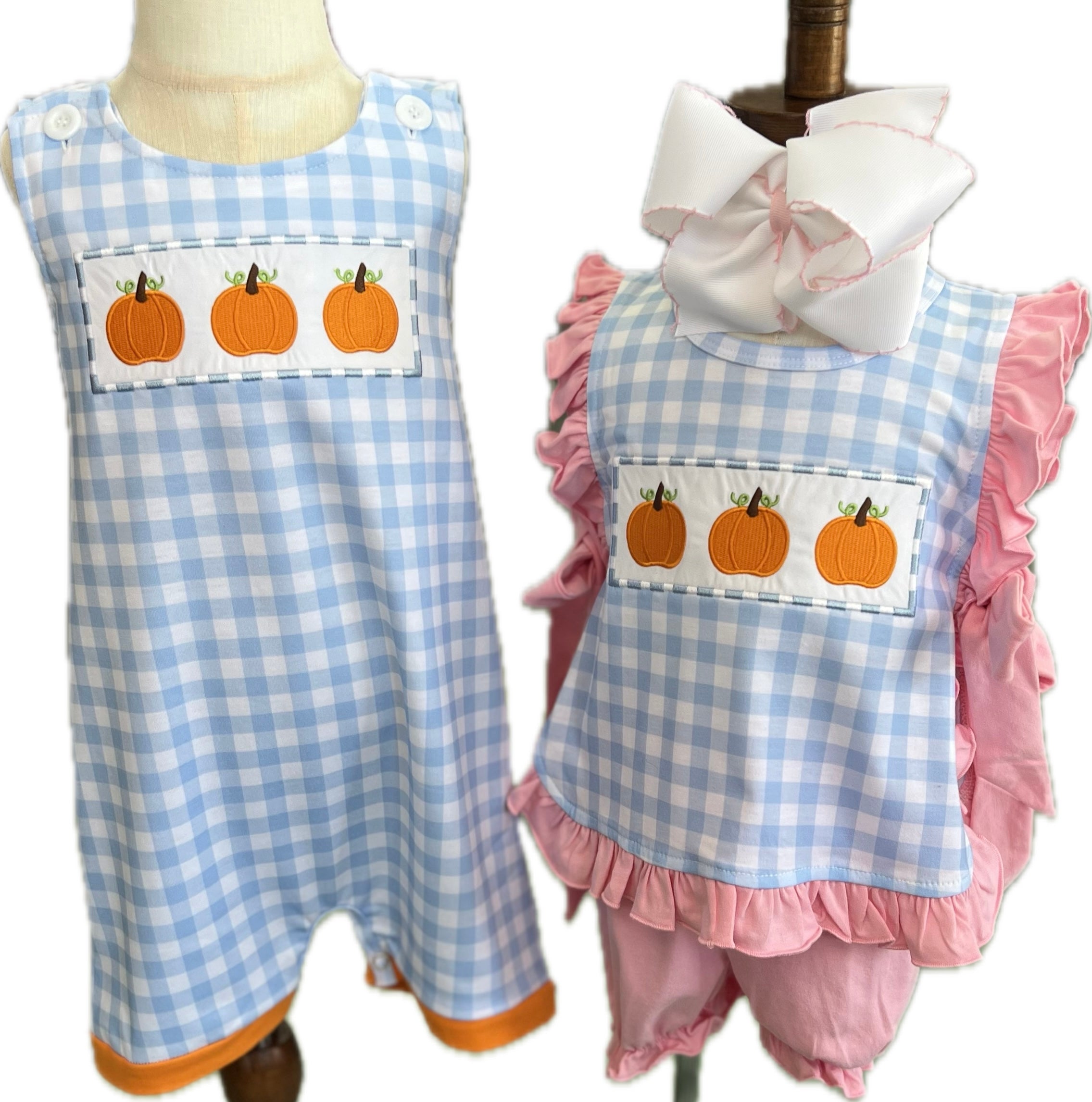 Two children's outfits with blue and pink checkered patterns and pumpkin patches on a white background.