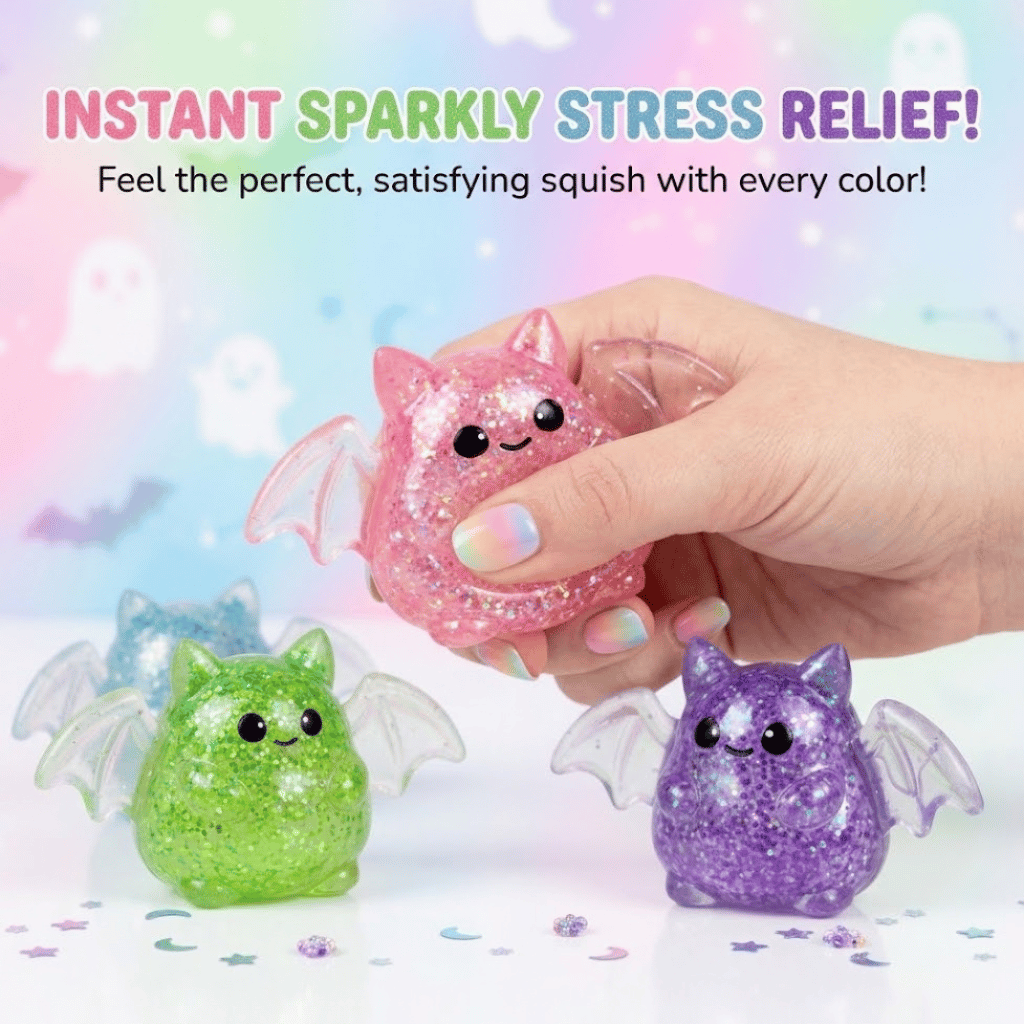 Hand squeezing a pink glitter bat squishy toy filled with sparkly beads
