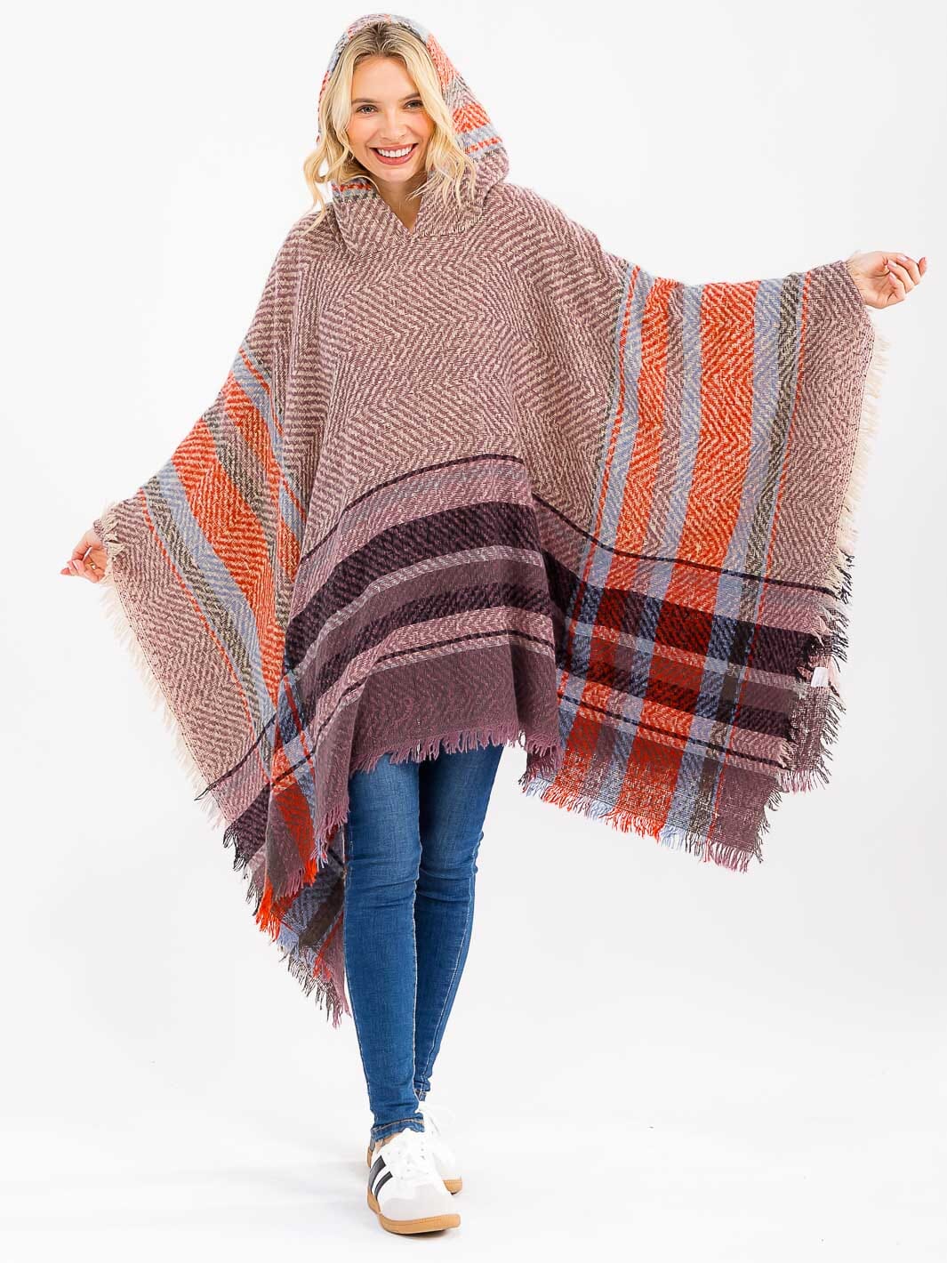 Woman wearing a plaid poncho with a white background
