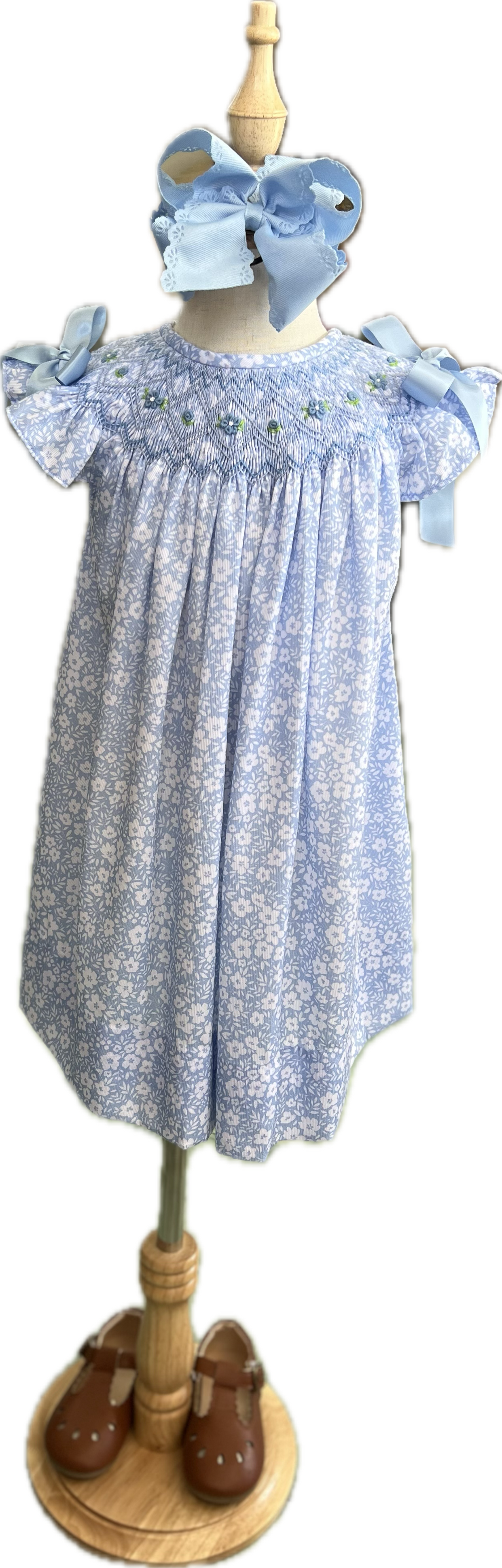 Children's dress with floral pattern on a mannequin
