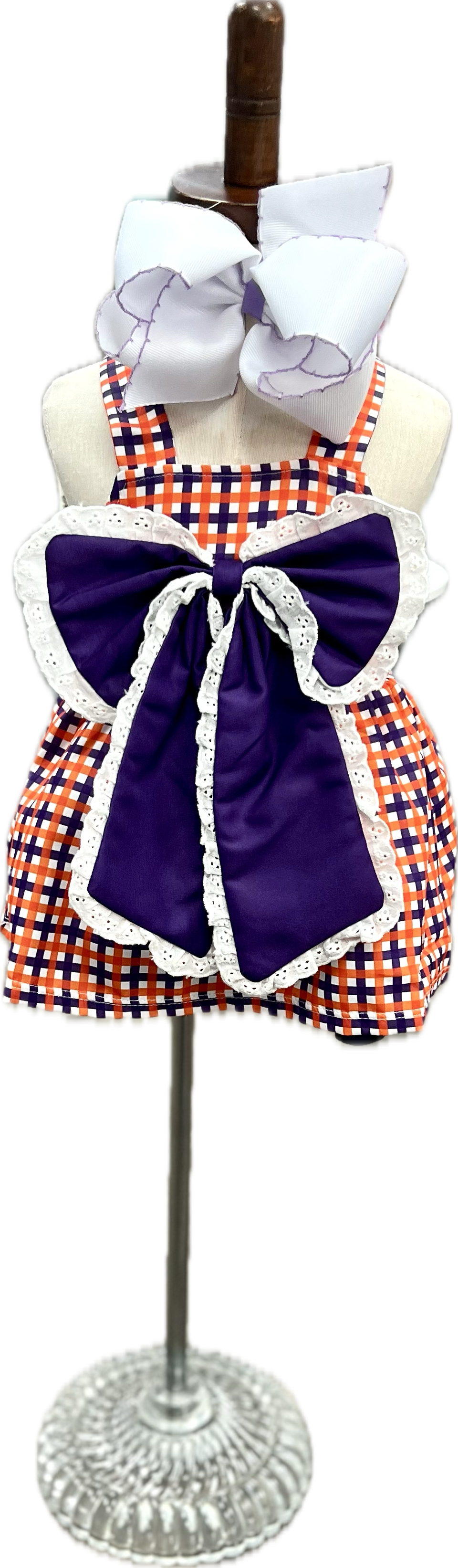 Checkered dress with purple accents on a mannequin against a white background