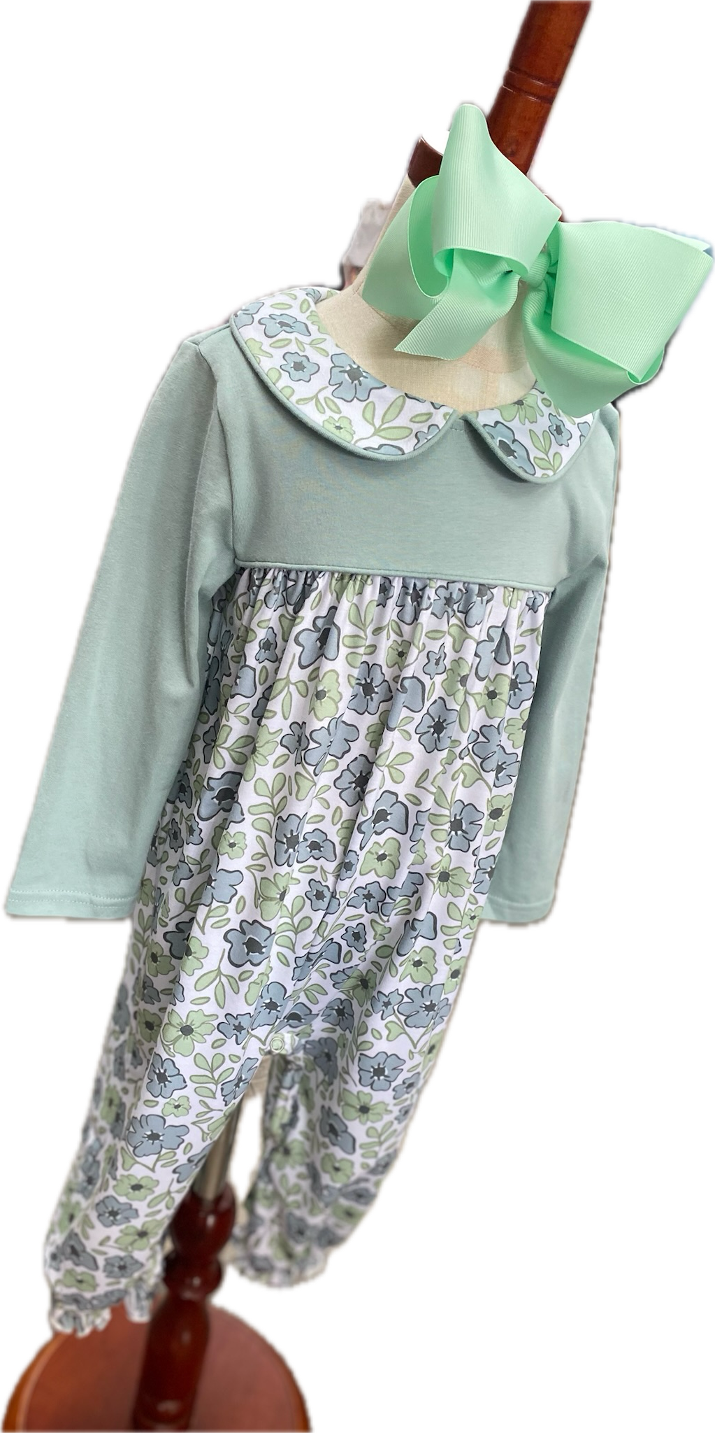 Little girl's long sleeve sage romper with floral print and matching floral print collar.