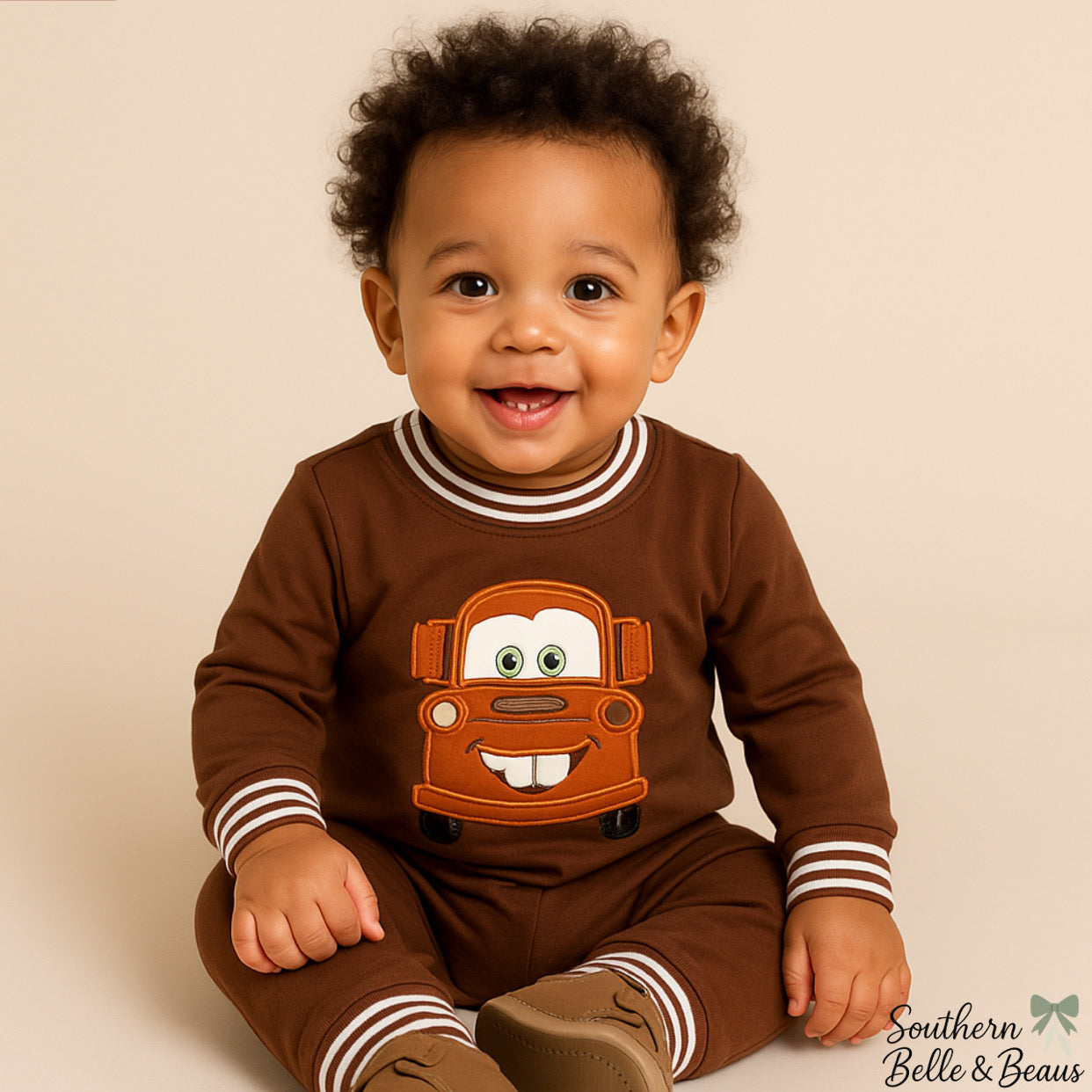 Brown baby bubble with Mater tow truck applique and striped trim.