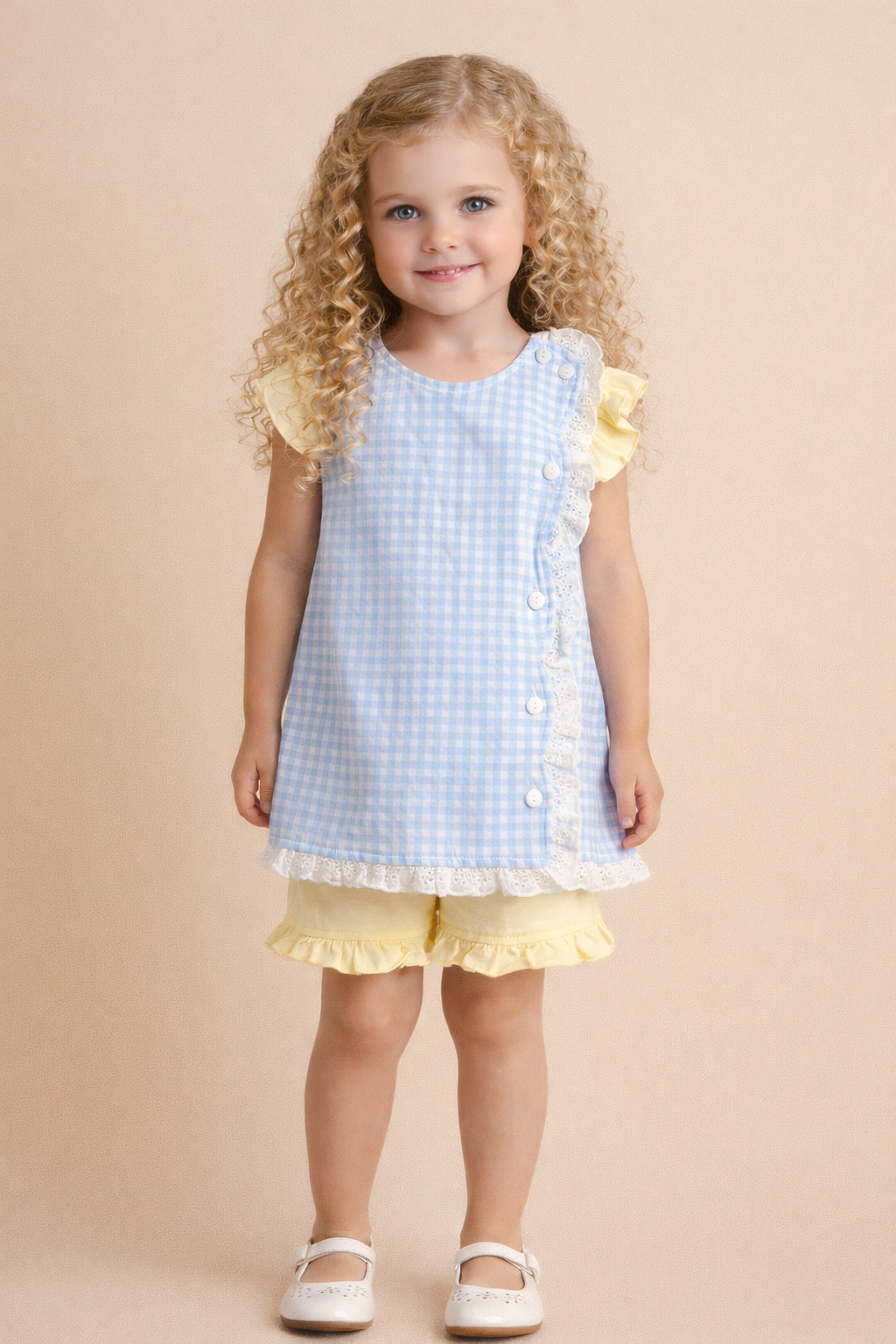 Young girl wearing a light blue gingham shirt with yellow accents, yellow shorts on a beige background