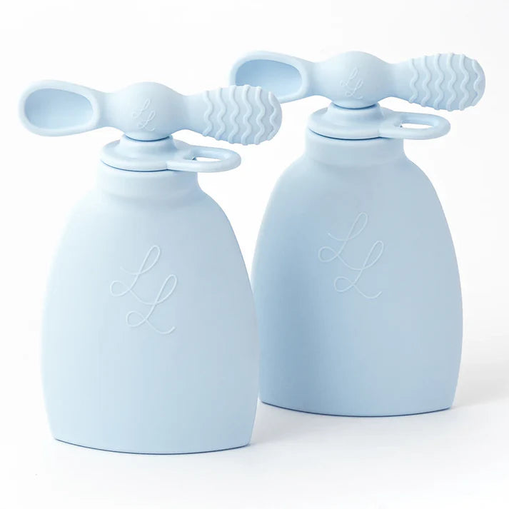 Two light blue silicone baby soothers on a white background