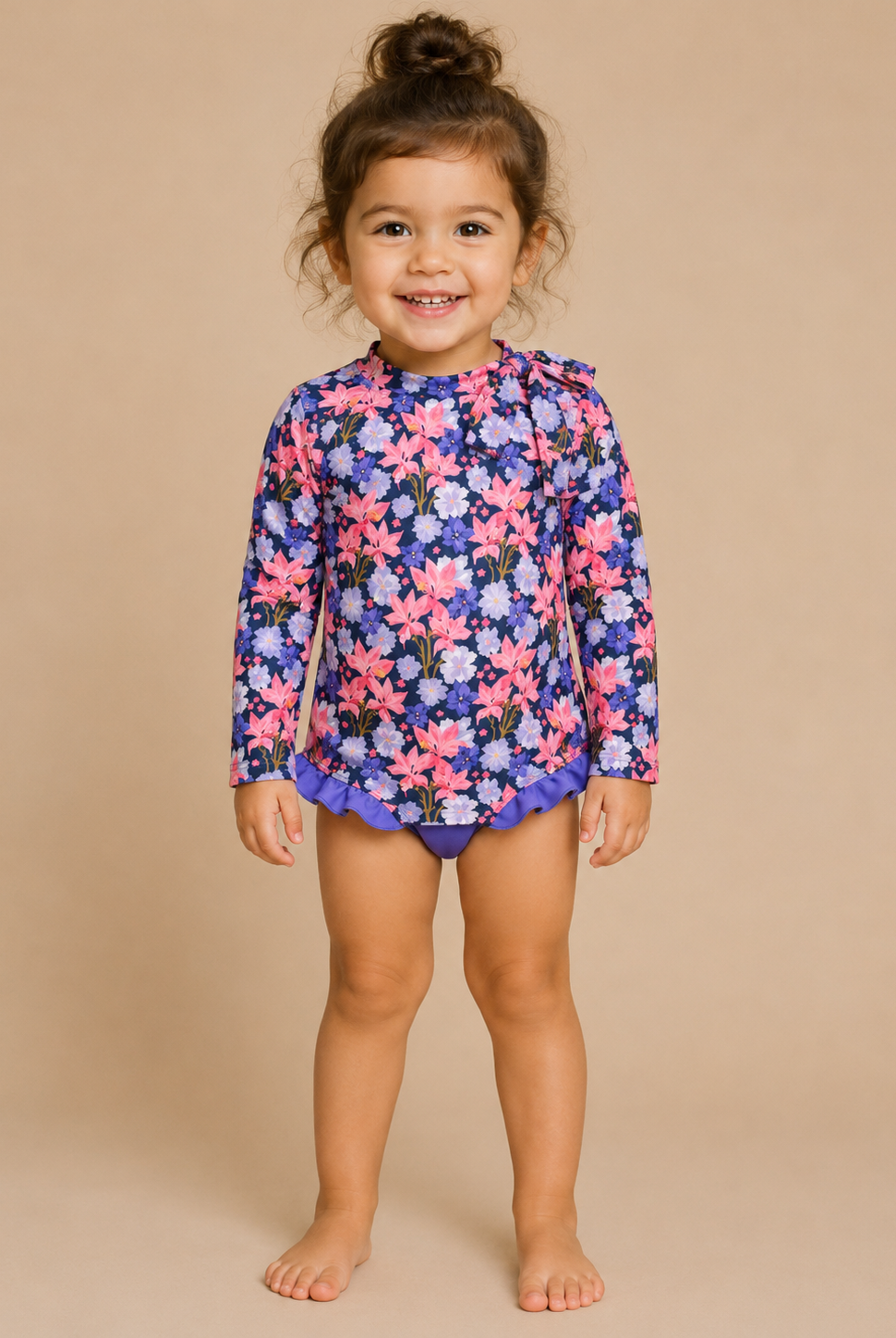 Child wearing a floral swimsuit on a beige background