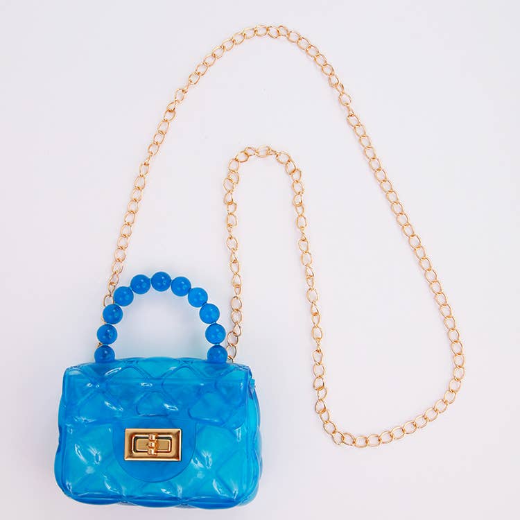 Blue handbag with gold chain on a white background