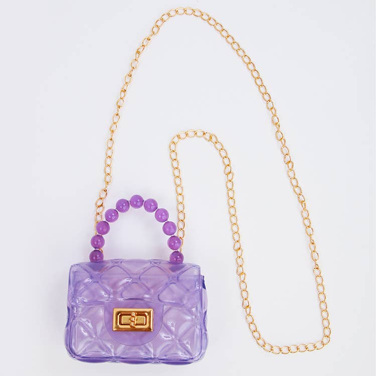 Purple handbag with a gold chain strap on a light gray background