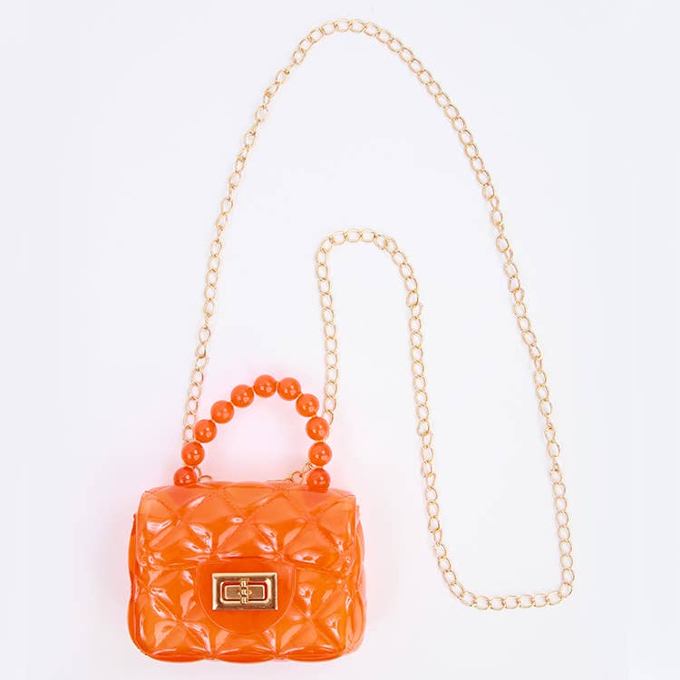 Orange quilted handbag with a chain strap on a white background