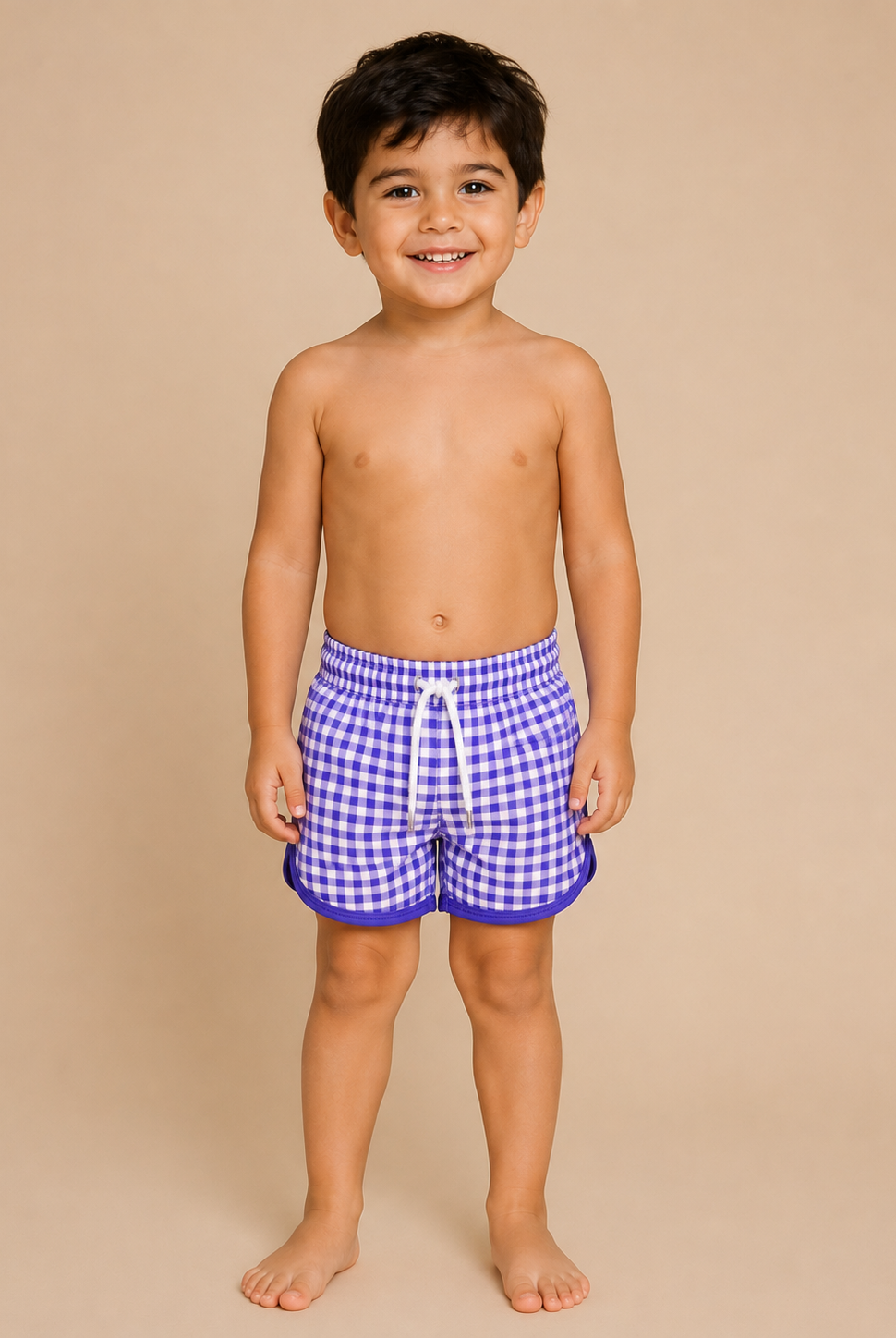 Child wearing blue checkered swim shorts on a beige background
