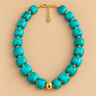 Turquoise Marble Bead Necklace is a women's turquoise green beaded statement necklace with gold-tone accents.