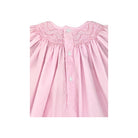 Pink checkered dress with smocked neckline on a white background