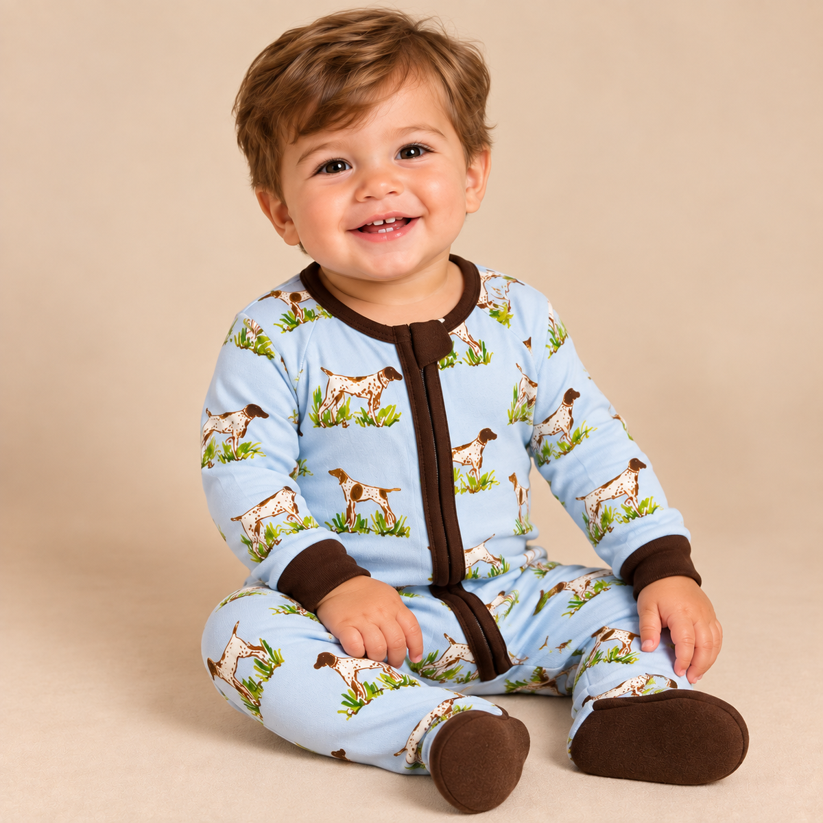 Infant boy wearing a bird dog print bamboo lounge zippie.