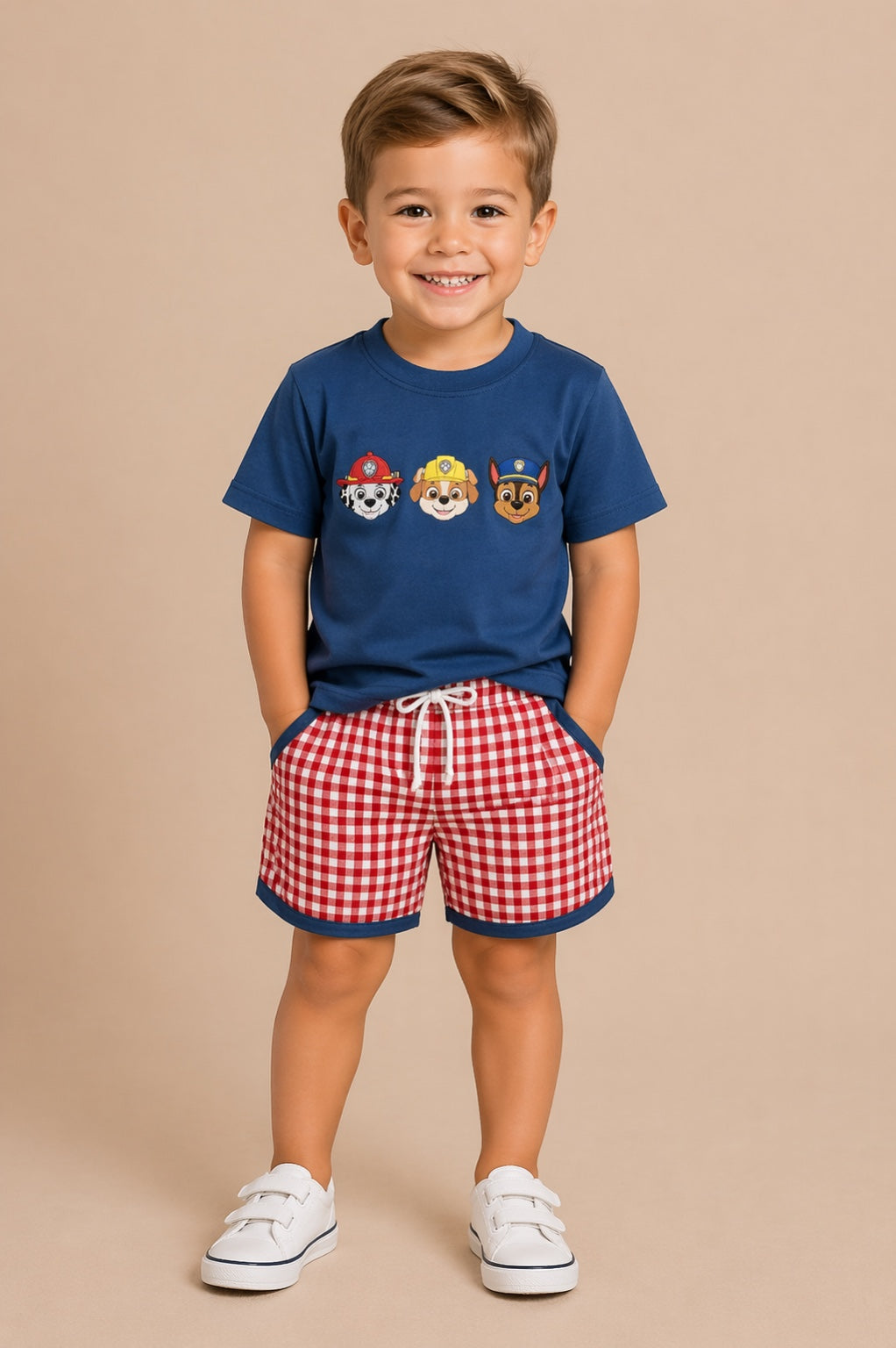 Child wearing a blue t-shirt with cartoon characters and red checkered shorts on a beige background