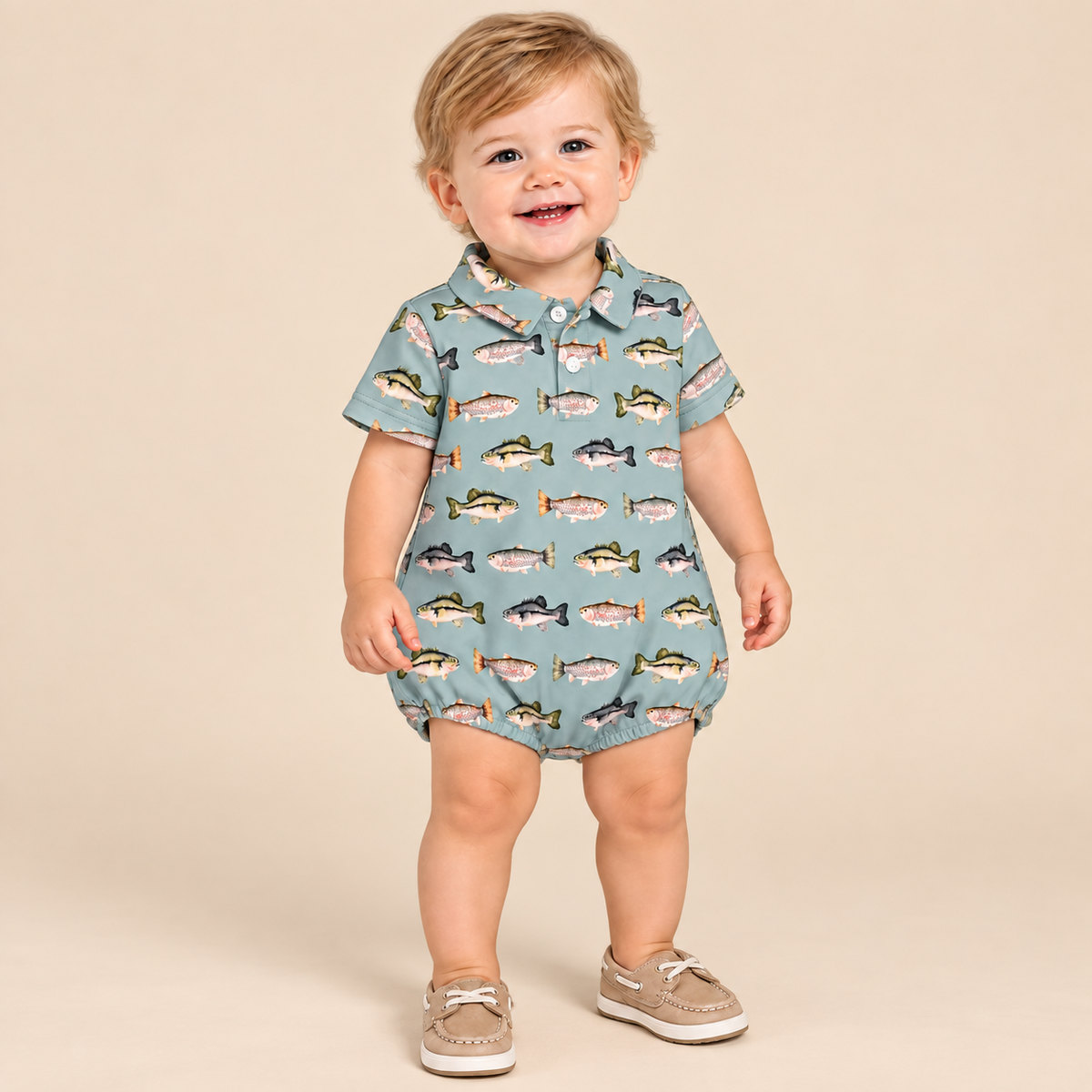 Toddler boy wearing a fish print bubble on a beige background.