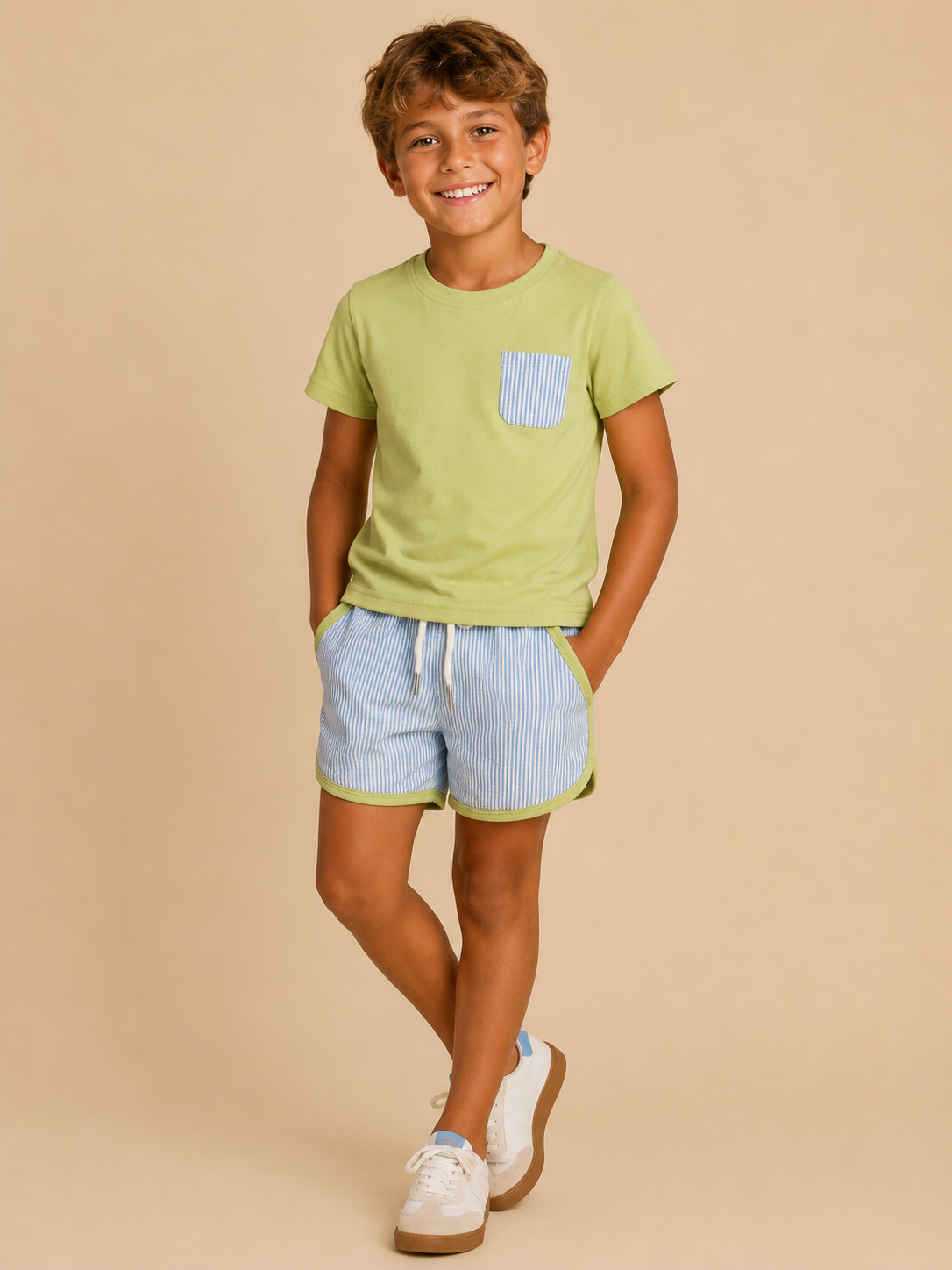 Child wearing a green t-shirt with a pocket and light blue shorts on a beige background