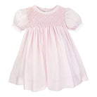 Pink dress with smocked bodice on a white background
