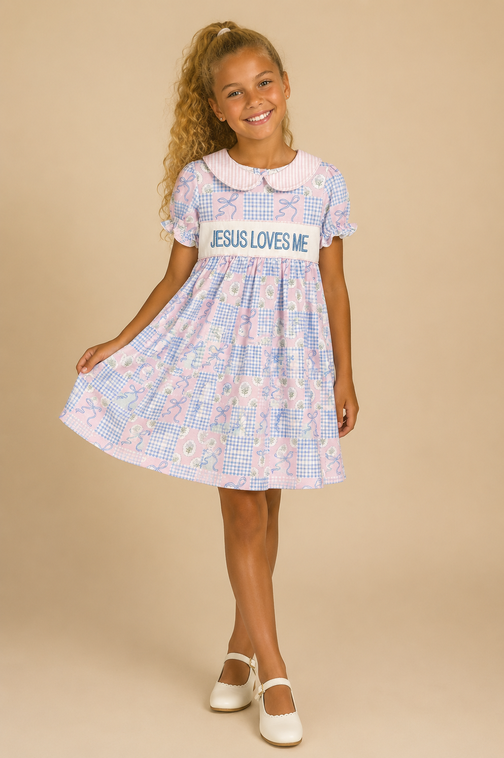 Young girl wearing a dress with 'Jesus Loves Me' text on a beige background