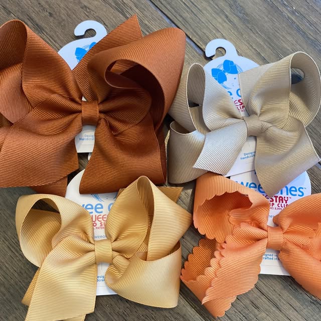 fall color wee ones bows on a wood counter