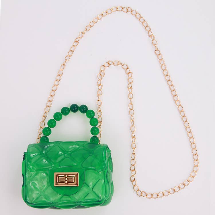 Green handbag with gold chain strap on a white background