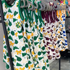 Children's dresses with sports team patterns on hangers