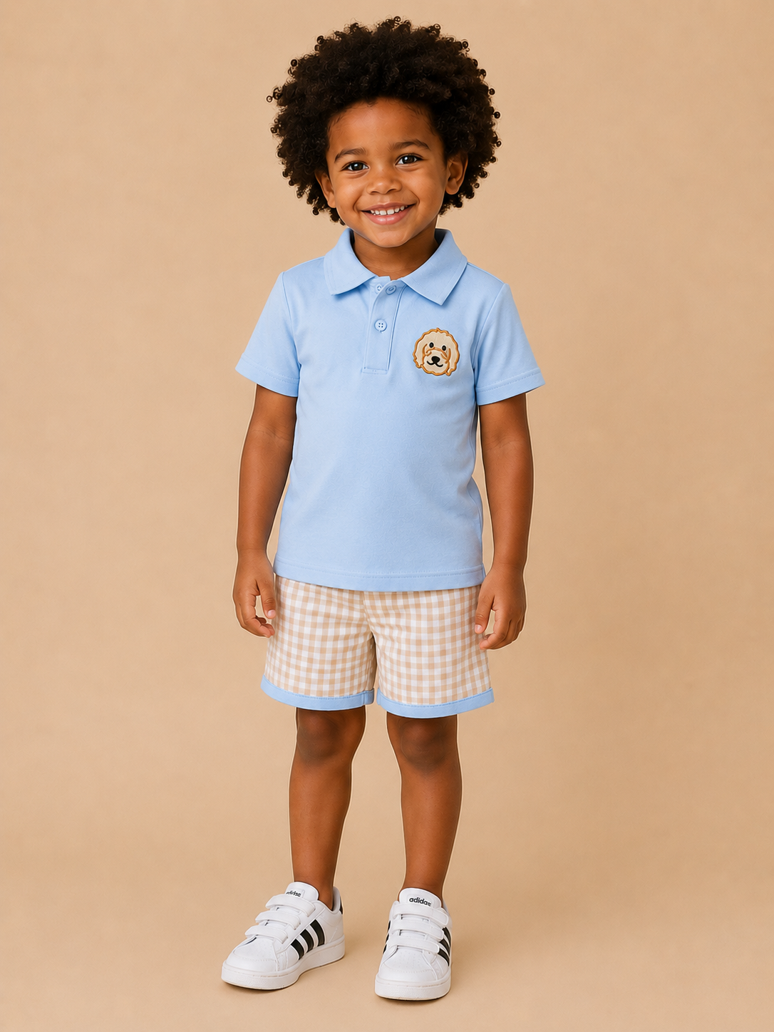 Boy wearing blue doodle dog polo shirt and plaid shorts set