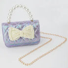 Purple handbag with a pearl bow and chain strap on a light gray background
