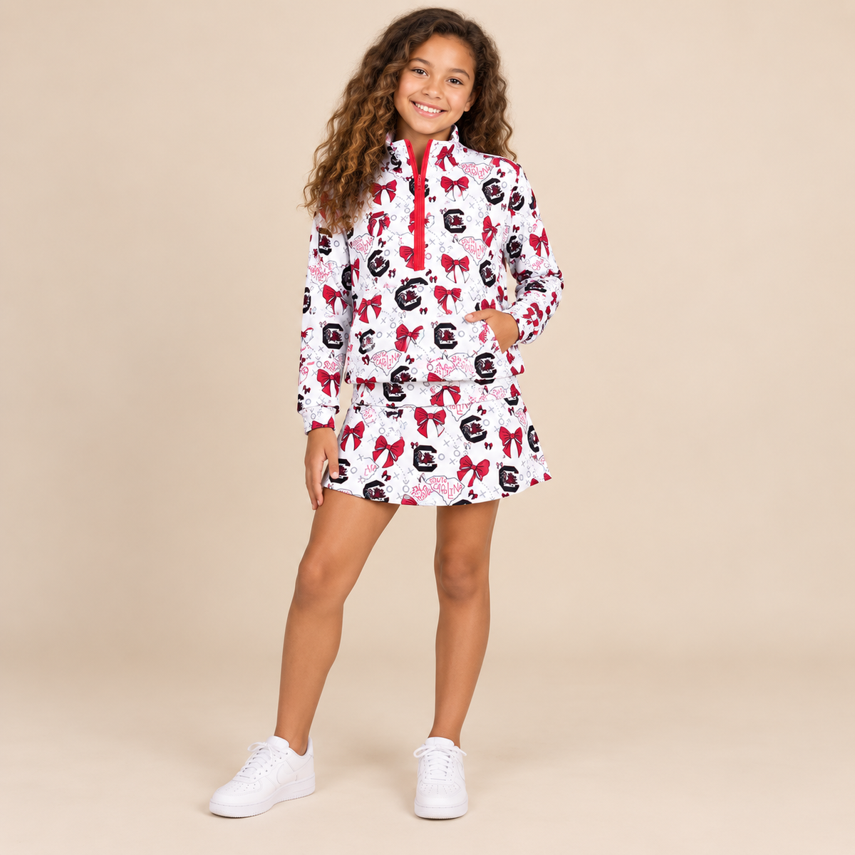 Tween girl girl wearing a gameday skort set with matching long sleeve top.