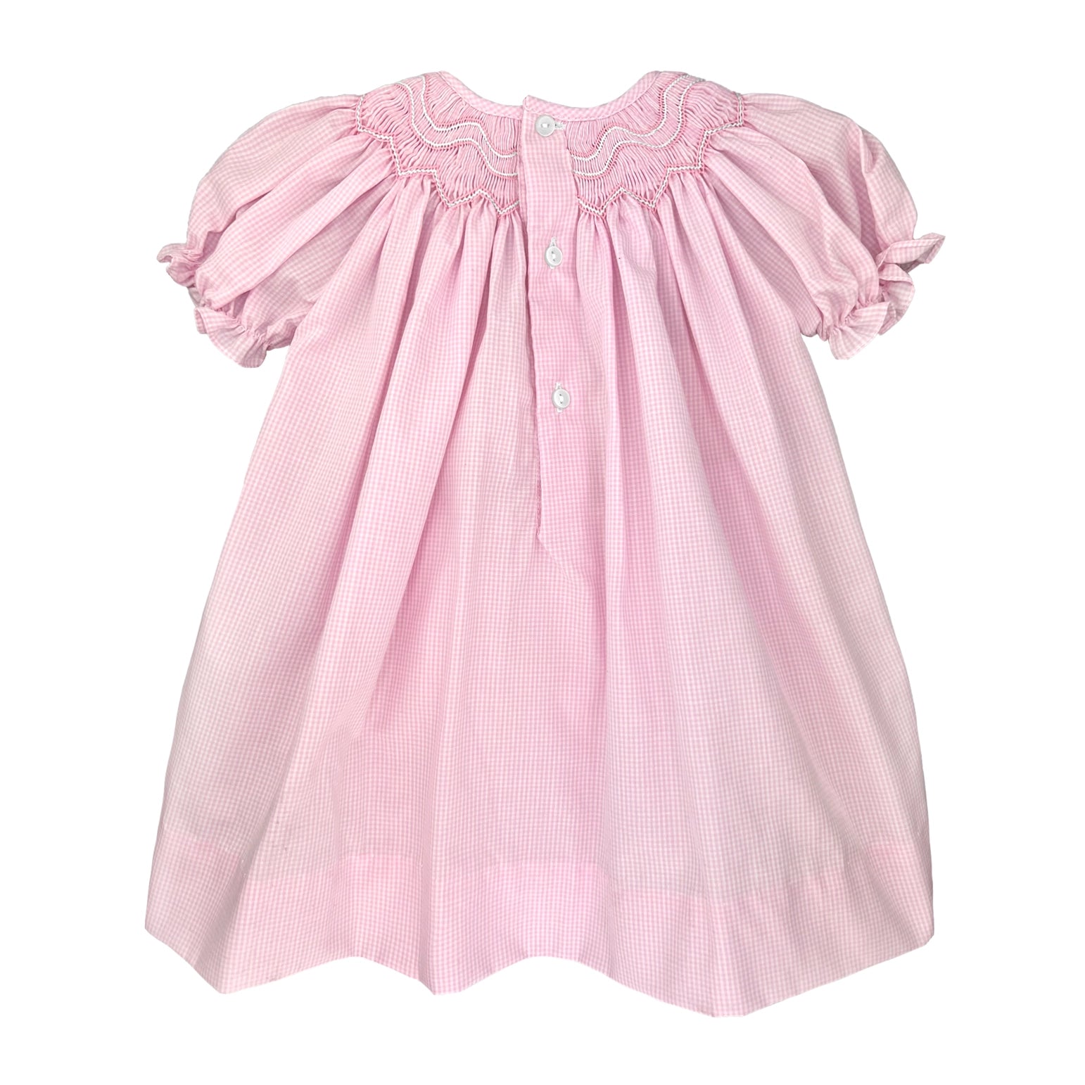 Pink dress with smocked neckline and puff sleeves on a white background