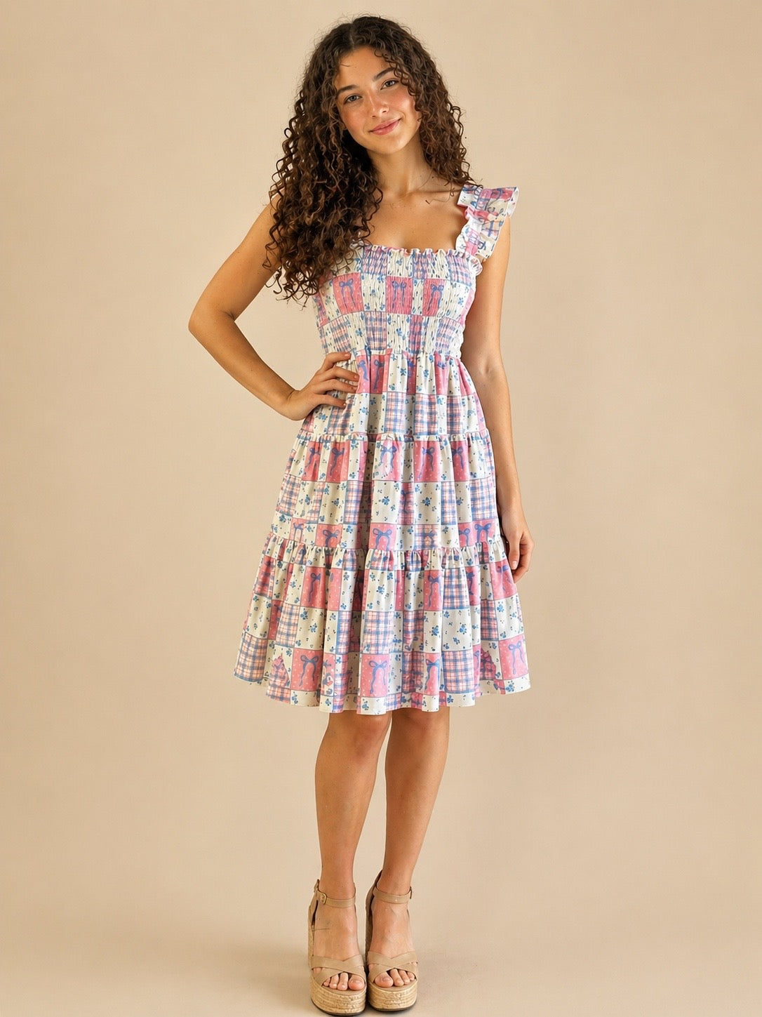 Woman wearing a colorful checkered dress against a beige background