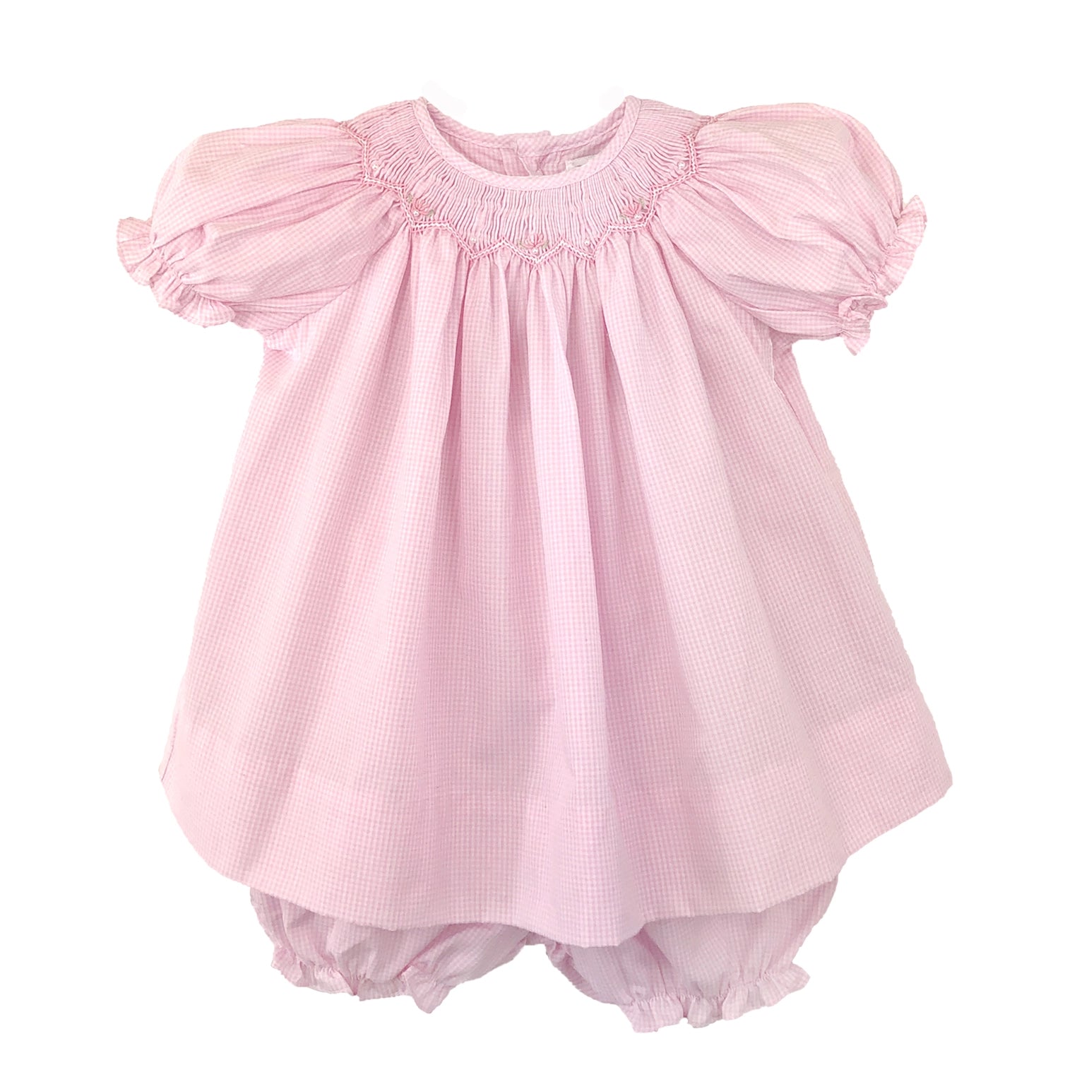 Pink baby dress with ruffled sleeves on a white background